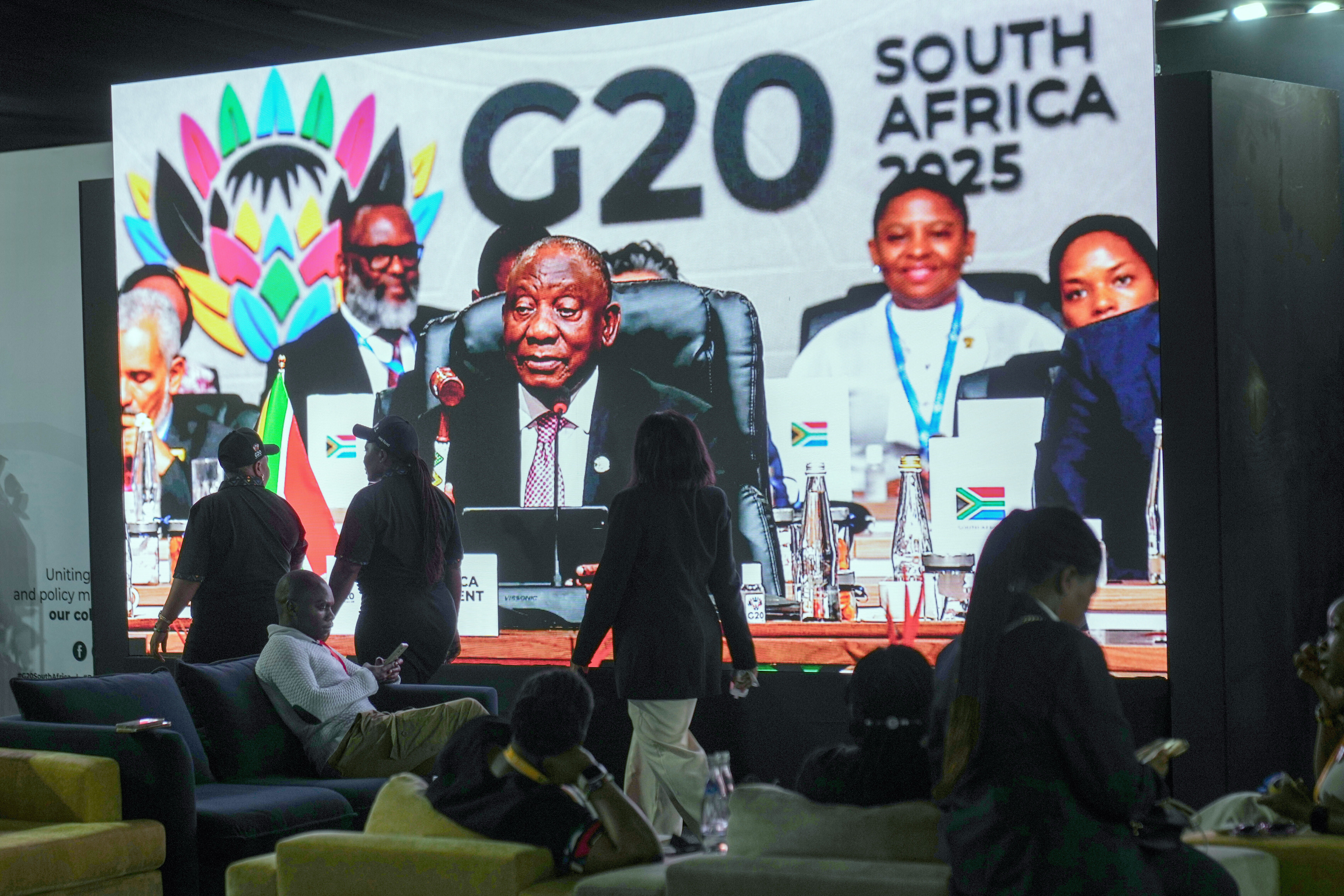 A screen shows the South African president Cyril Ramaphosa gavelling the end of the G20