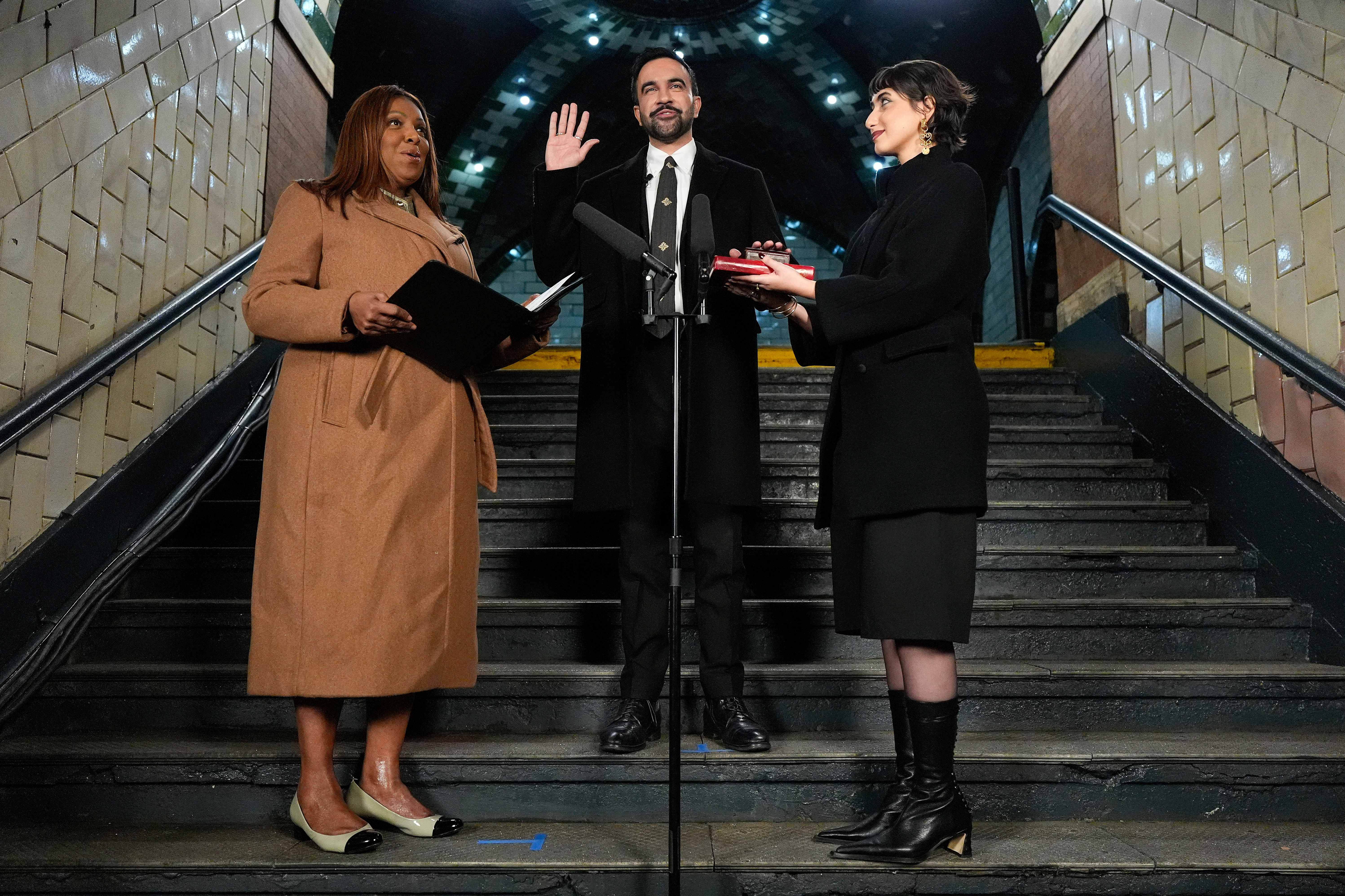 New York Attorney General Letitia James, left, administers the oath of office to mayor-elect Zohran Mamdani, center, as his wife Rama Duwaji looks on.