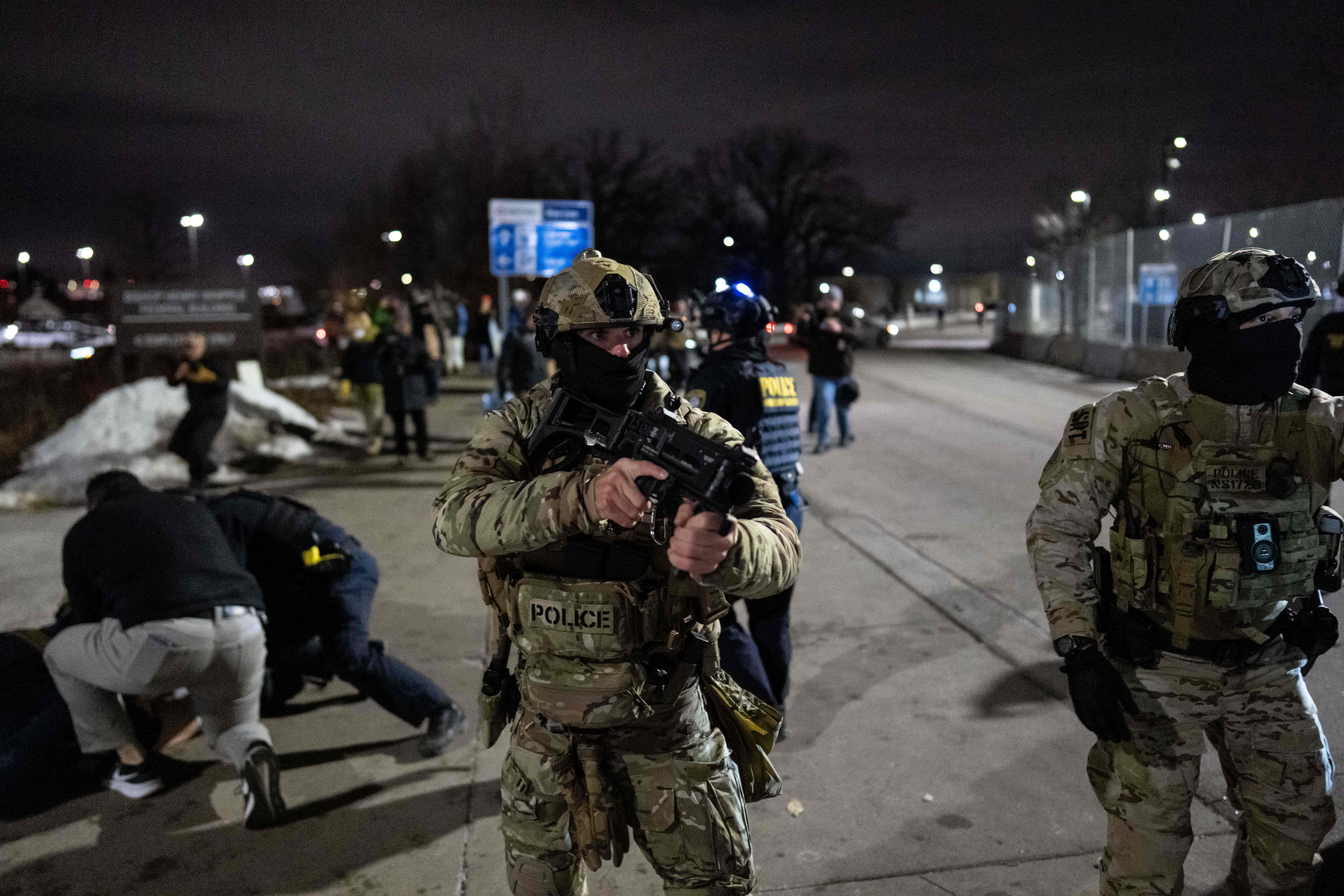 Federal immigration officers detain a protester.