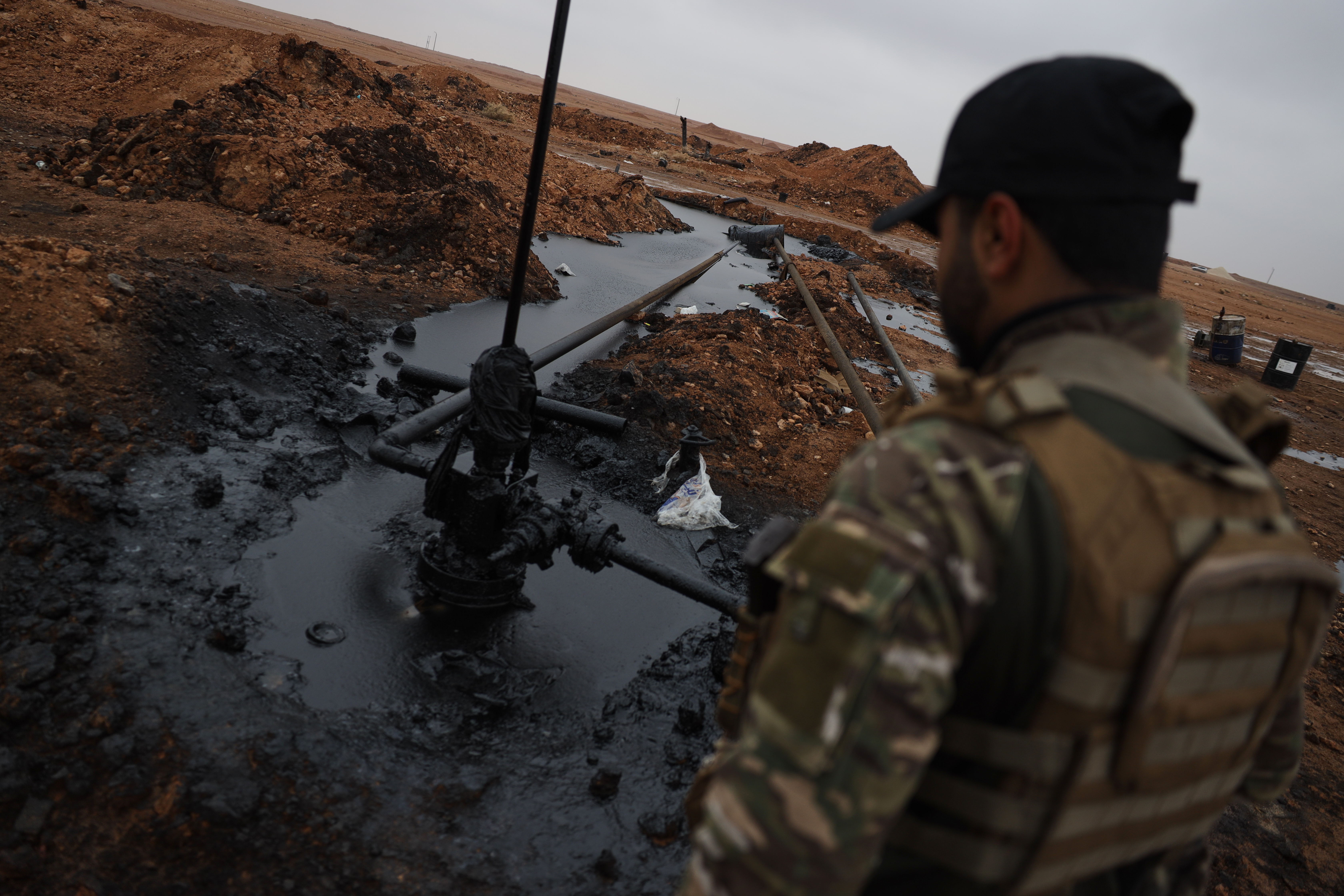 A Syrian government soldier walks at al-Thawra oil field after government troops took control of it on January 18, 2026