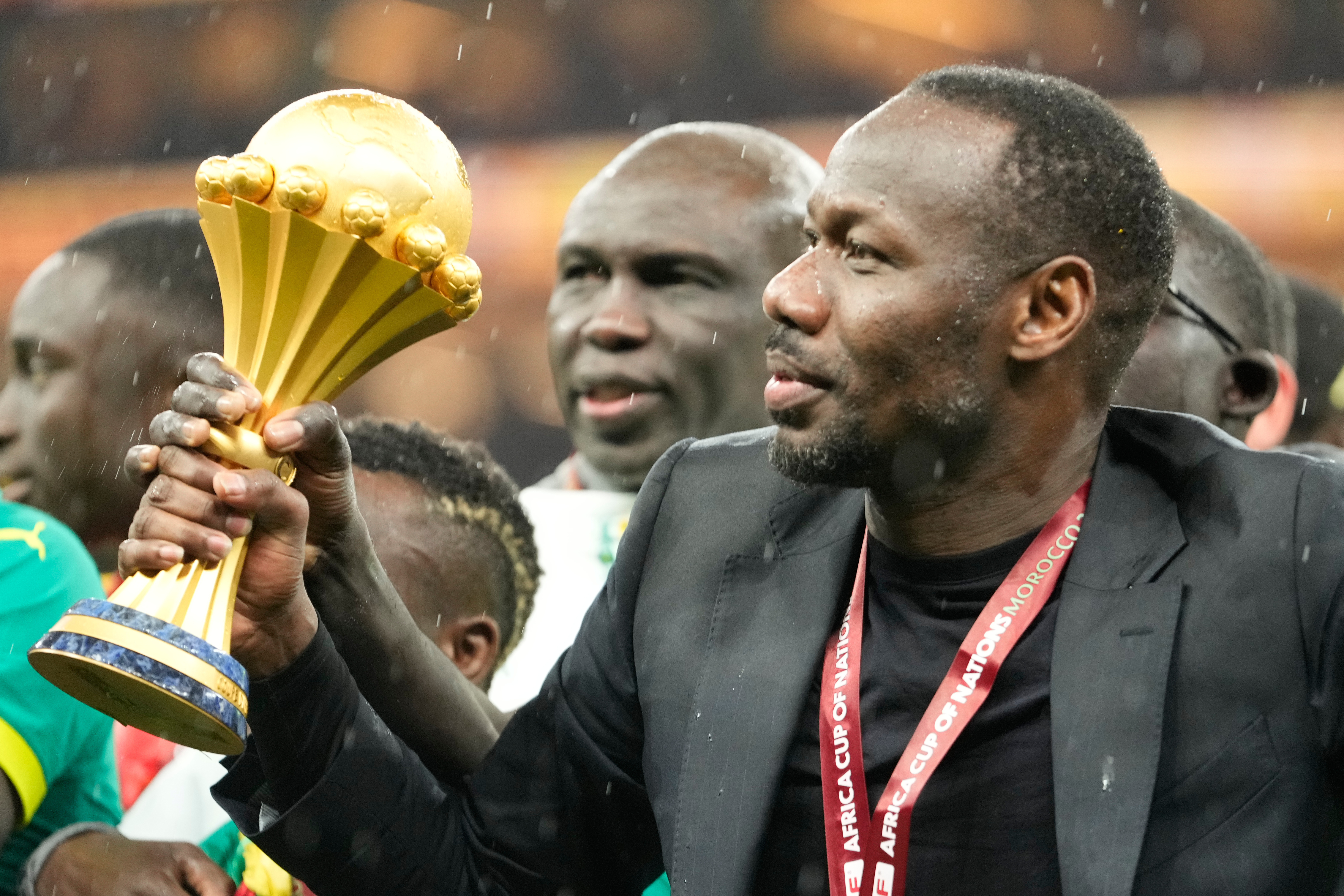 Senegal's head coach Pape Thiaw holds the trophy after winning the Africa Cup of Nations final