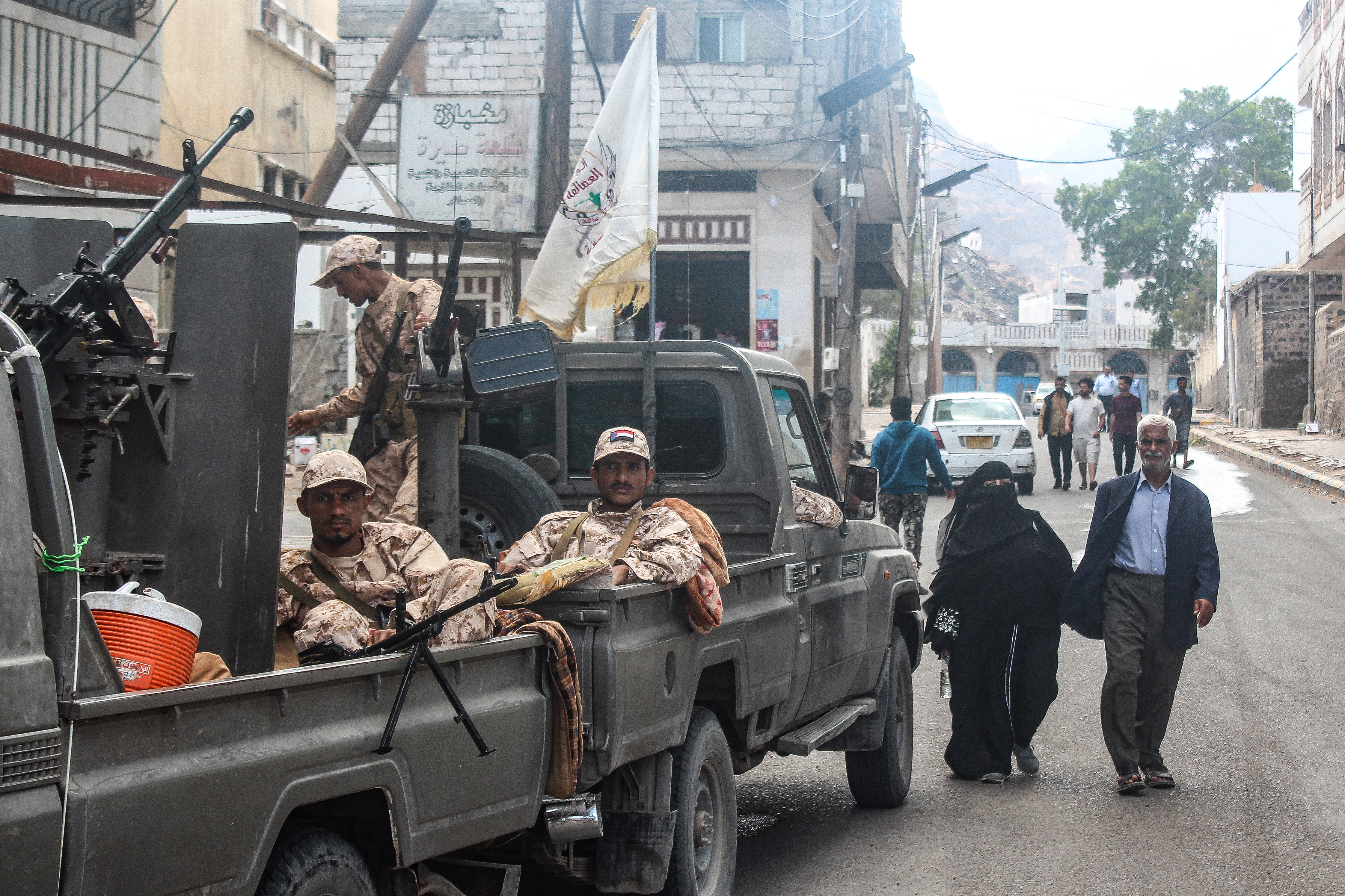 Members of the Southern Giants Brigade sit in the back of military vehicles.