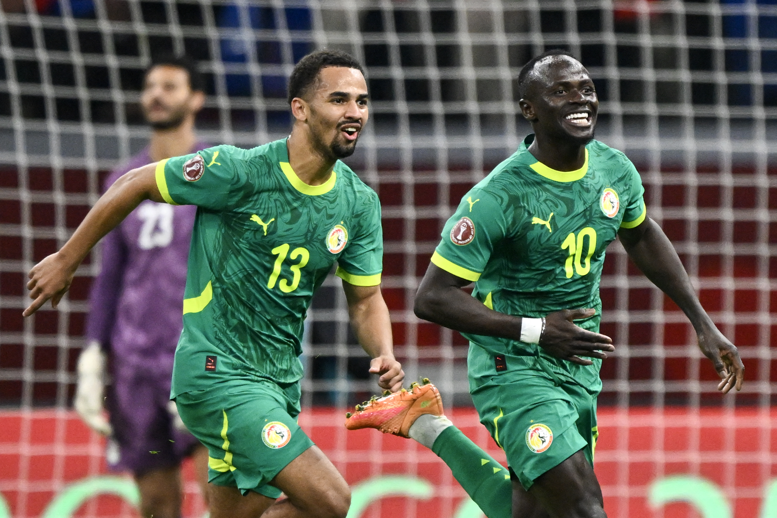 Senegal's forward #10 Sadio Mane celebrates his goal with Senegal's forward #13 Iliman Ndiaye during the Africa Cup of Nations (CAN) semi-final football match between Senegal and Egypt at the Grand stadium in Tangiers on January 14, 2026.