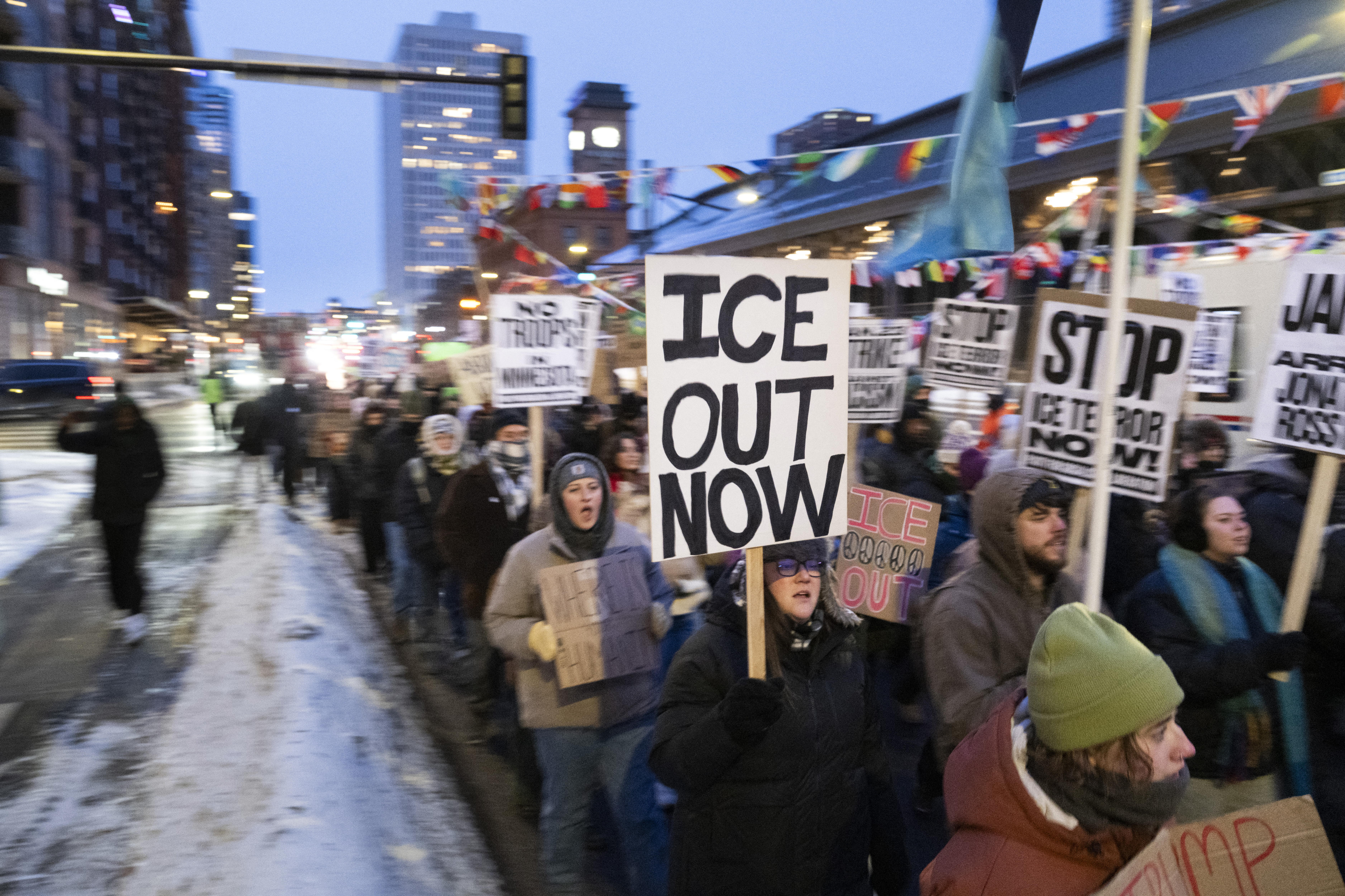 Demonstrators march during the nationwide "Stop ICE Terror" rally through downtown Minneapolis, Minnesota, on January 20, 2026 in protest against US President Donald Trump's policies.