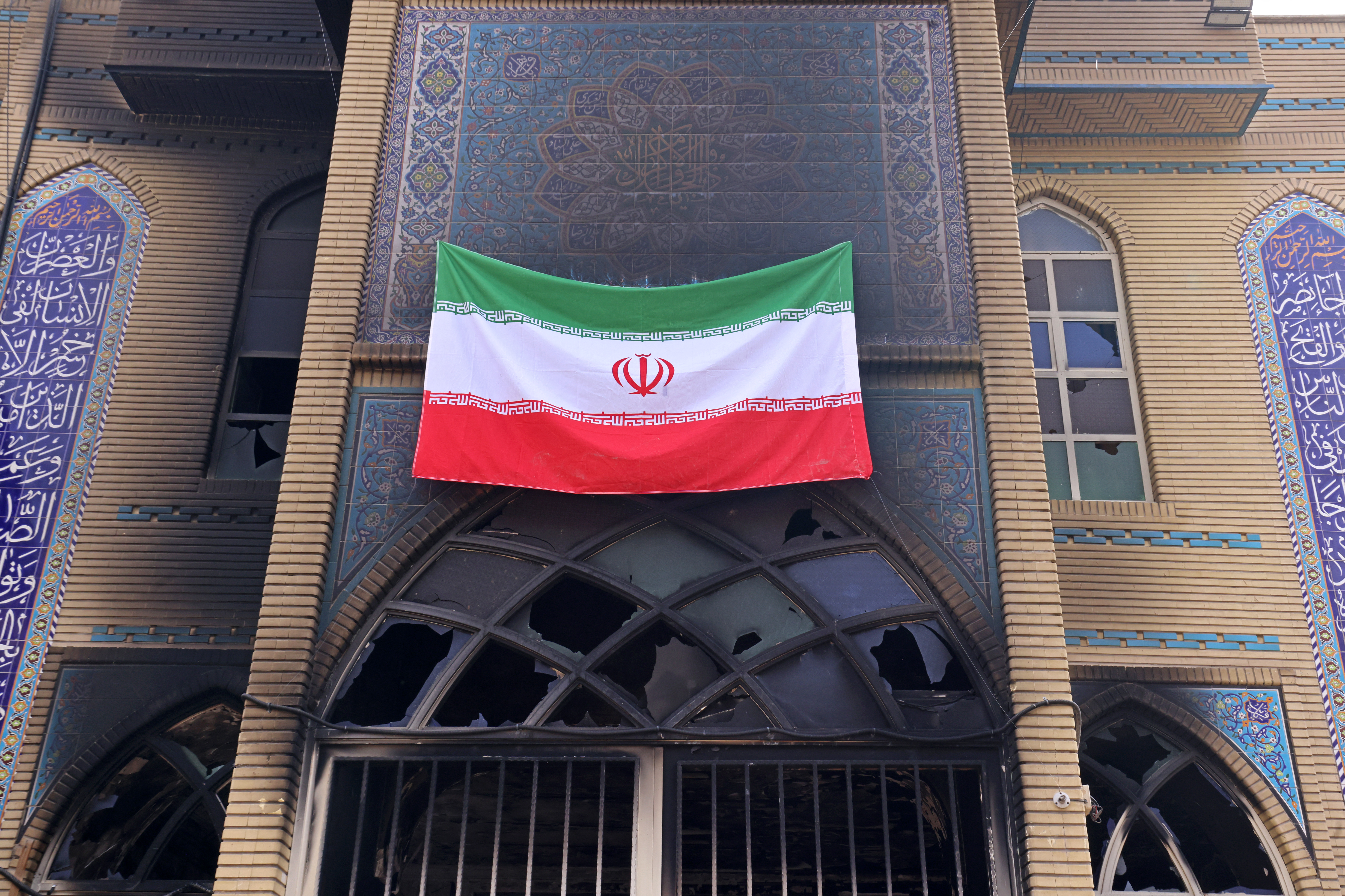 This photograph taken during a tour for foreign media shows an Iranian national flag installed on the Beheshti Mosque that was damaged during recent public protests, in Tehran on January 21, 2026.