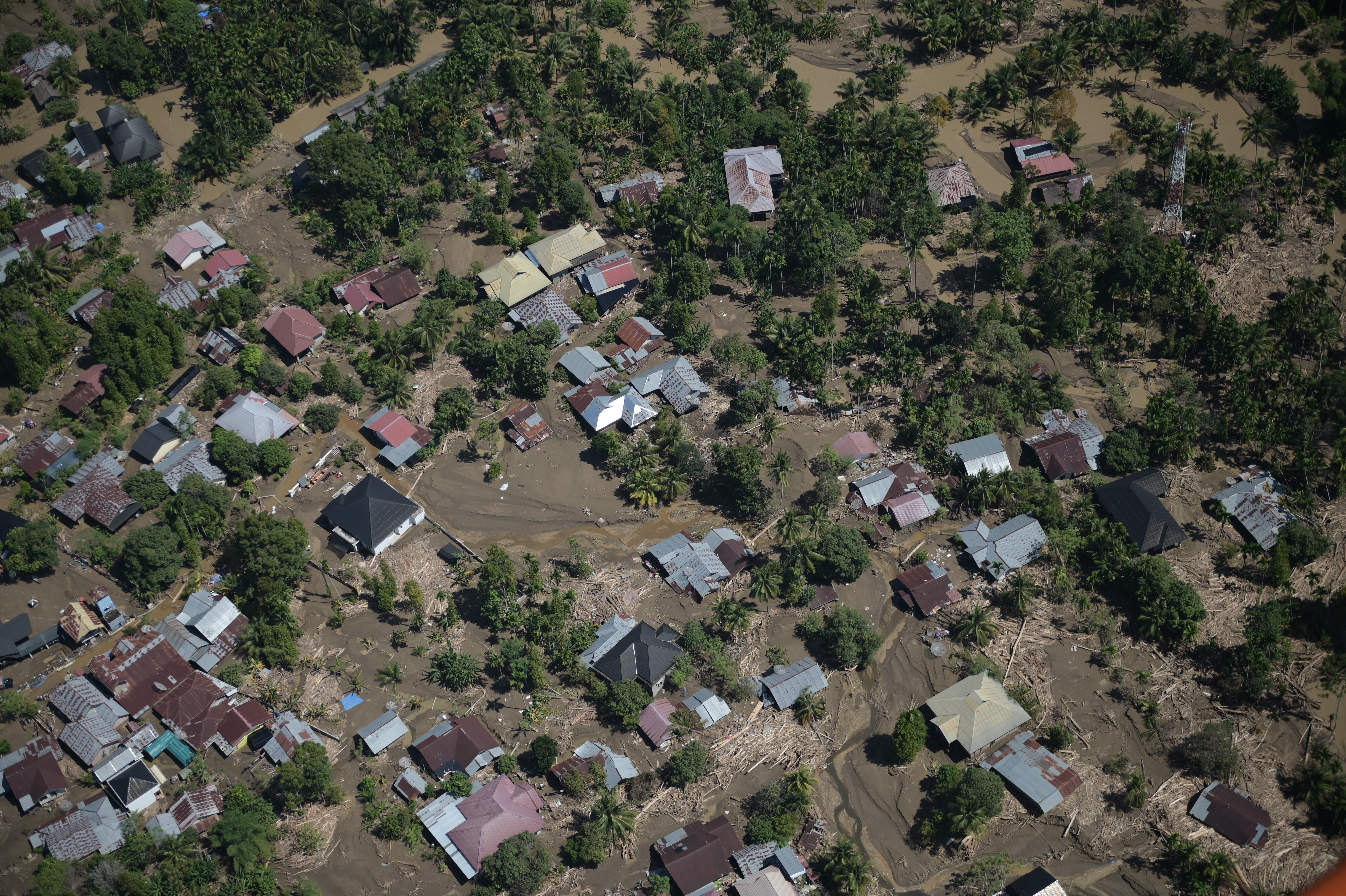 FILE - This photo taken from a national disaster mitigation agency's helicopter during an aerial aid distribution shows an area affected by floods in the aftermath of Cyclone Senyar in Pidie Jaya, Aceh province, Indonesia, Dec. 4, 2025. (AP Photo/Reza Saifullah, File)