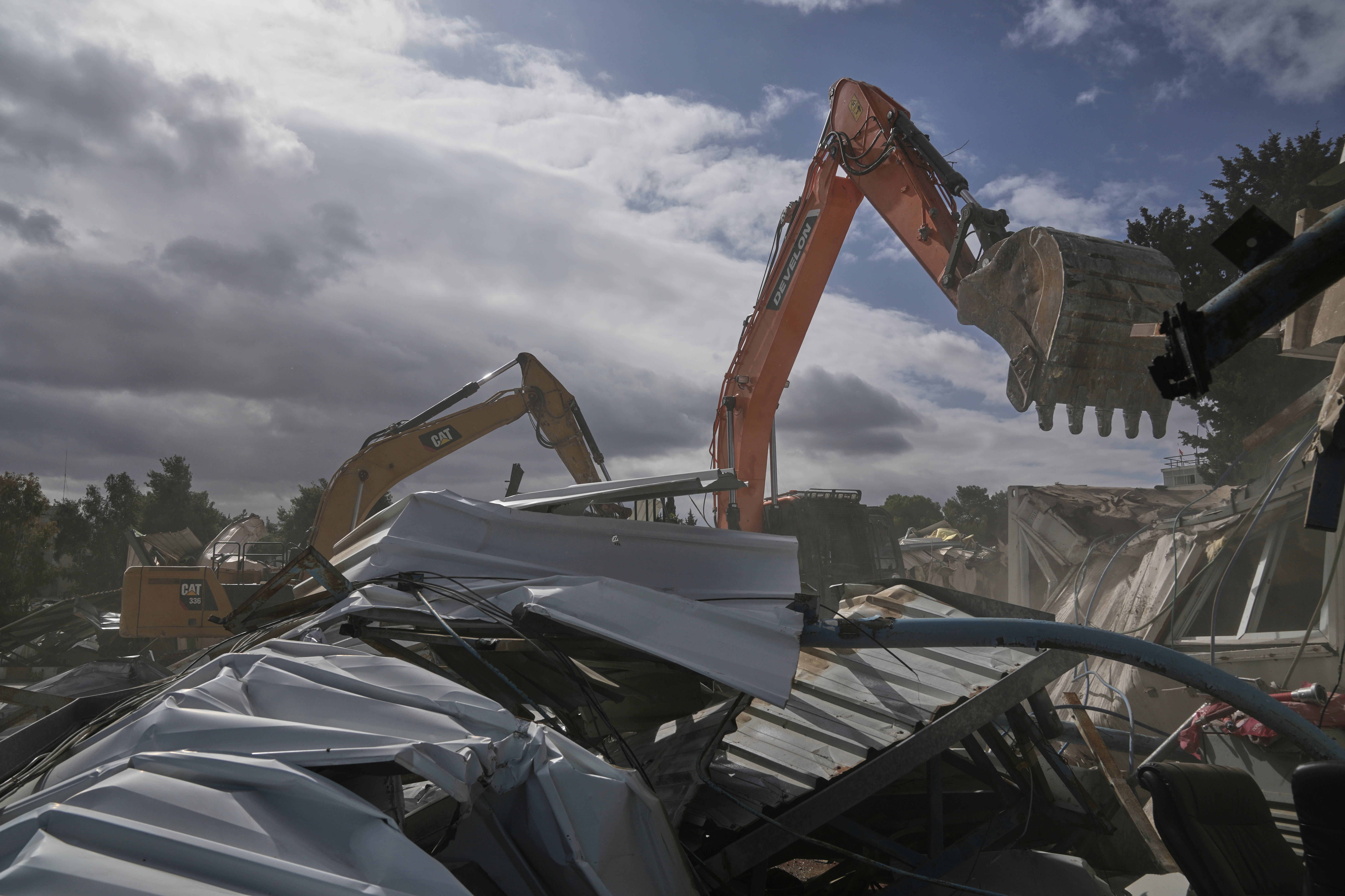 Israeli bulldozers demolish a UNRWA compound, belonging to the U.N. agency that assists Palestinian refugees, in east Jerusalem Tuesday, Jan. 20, 2026. (AP Photo/Mahmoud Illean)