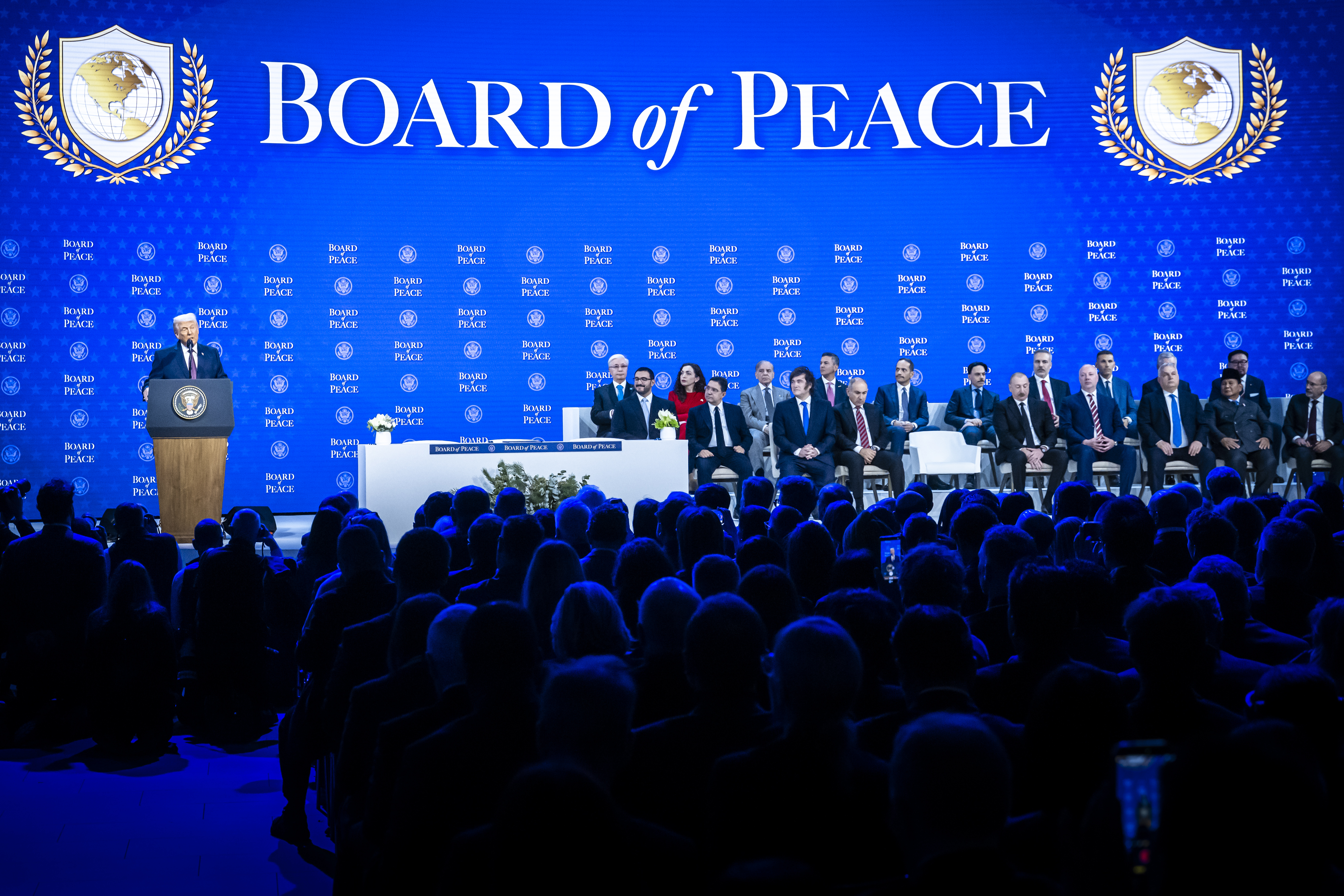 epa12670236 US President Donald Trump (L) speaks at the 'Board of Peace' meeting during the 56th annual meeting of the World Economic Forum (WEF), in Davos, Switzerland, 22 January 2026. The 2026 summit, running from 19 to 23 January and held under the theme 'A Spirit of Dialogue,' brings together global political leaders, corporate executives, and scientists to address international challenges. EPA/GIAN EHRENZELLER