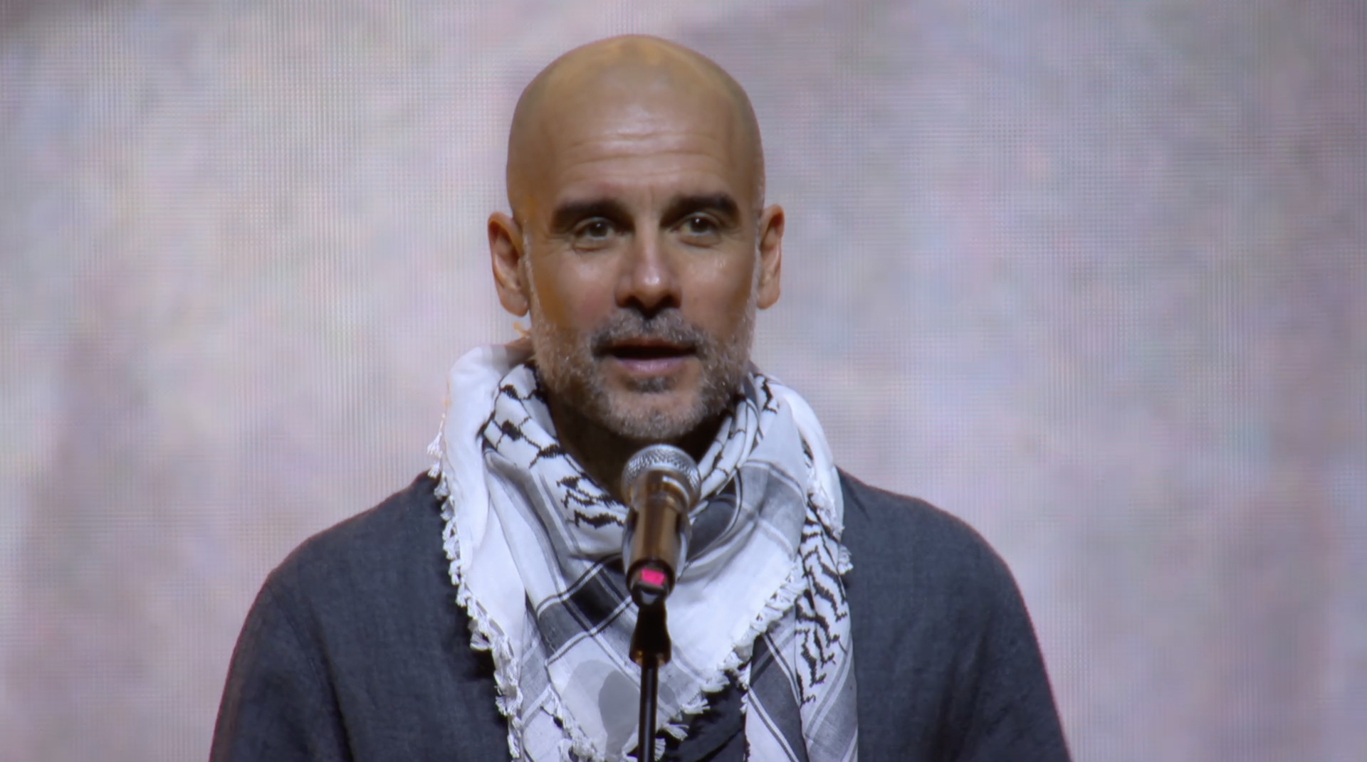 Manchester City manager Pep Guardiola wore a keffiyeh and condemned global silence over Palestinian children&rsquo;s suffering at a concert in Barcelona, Spain. [ACT X PALESTINE/Instagram]