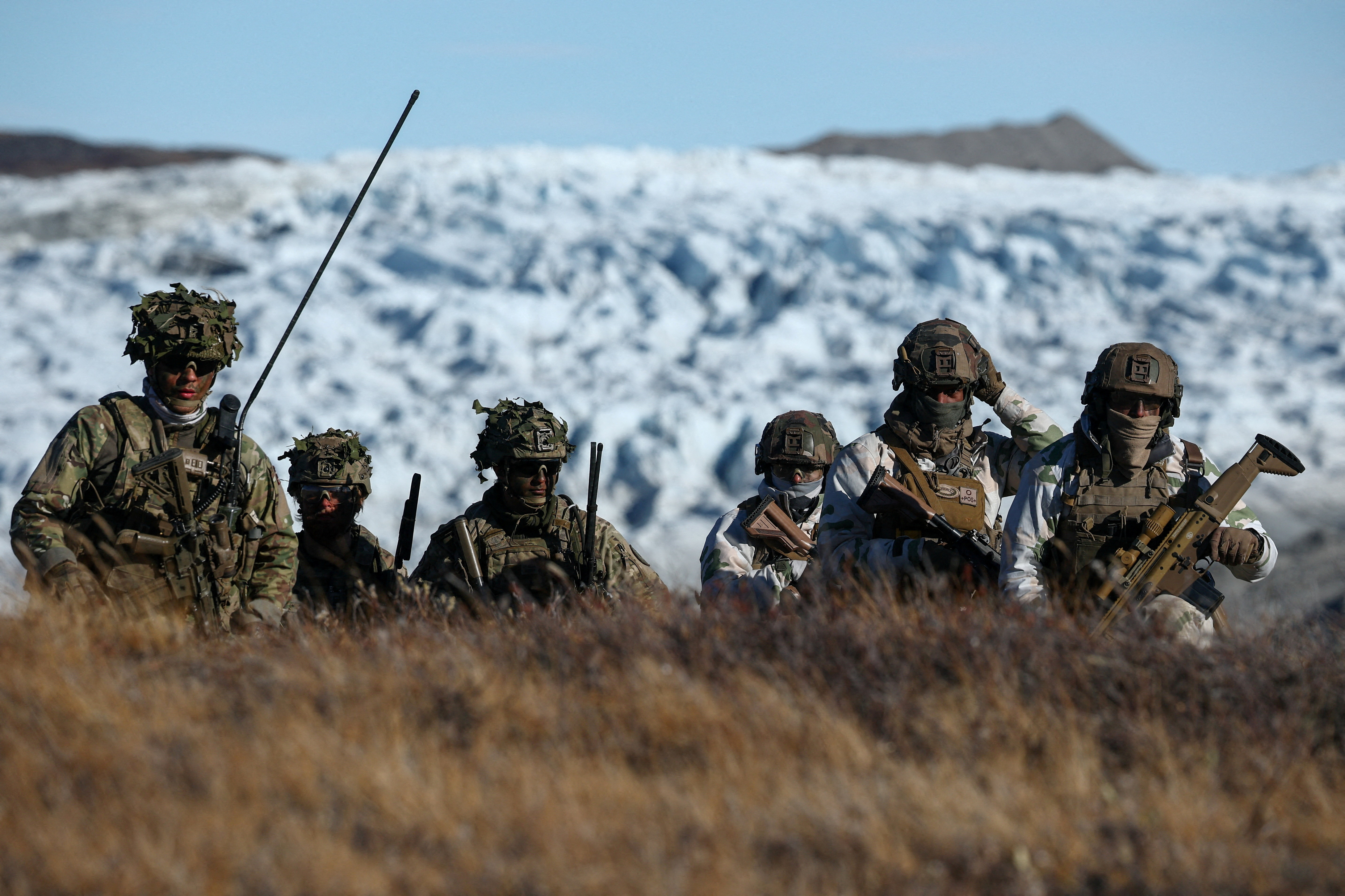 FILE PHOTO: Members of the Danish armed forces practice looking for potential threats during a military drill as Danish, Swedish and Norwegian home guard units together with Danish, German and French troops take part in joint military drills in Kangerlussuaq, Greenland, September 17, 2025. REUTERS/Guglielmo Mangiapane/File Photo