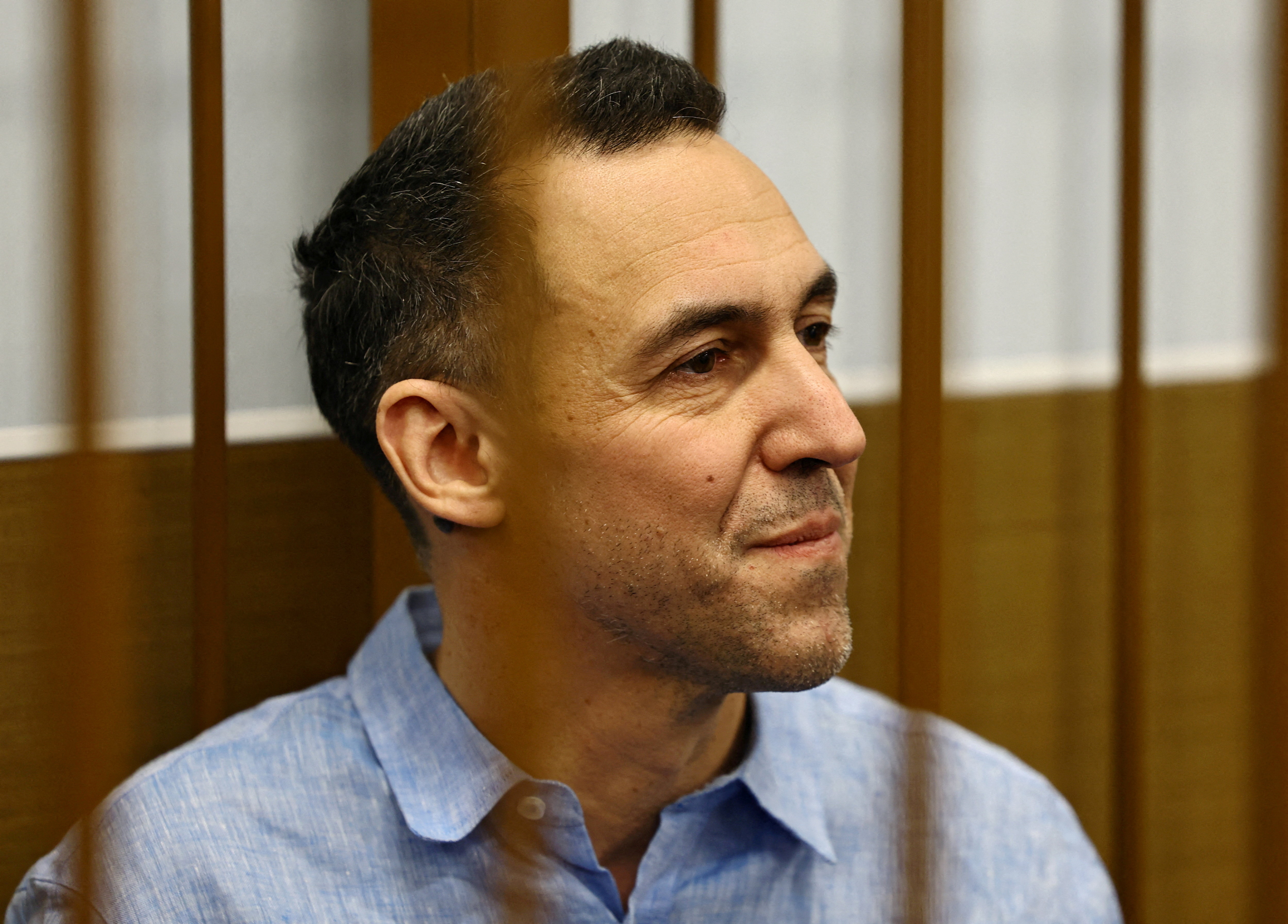 FILE PHOTO: French researcher Laurent Vinatier, who is suspected of illegally collecting sensitive Russian military information, sits inside an enclosure for defendants before a court hearing in Moscow, Russia October 14, 2024. REUTERS/Evgenia Novozhenina/File Photo
