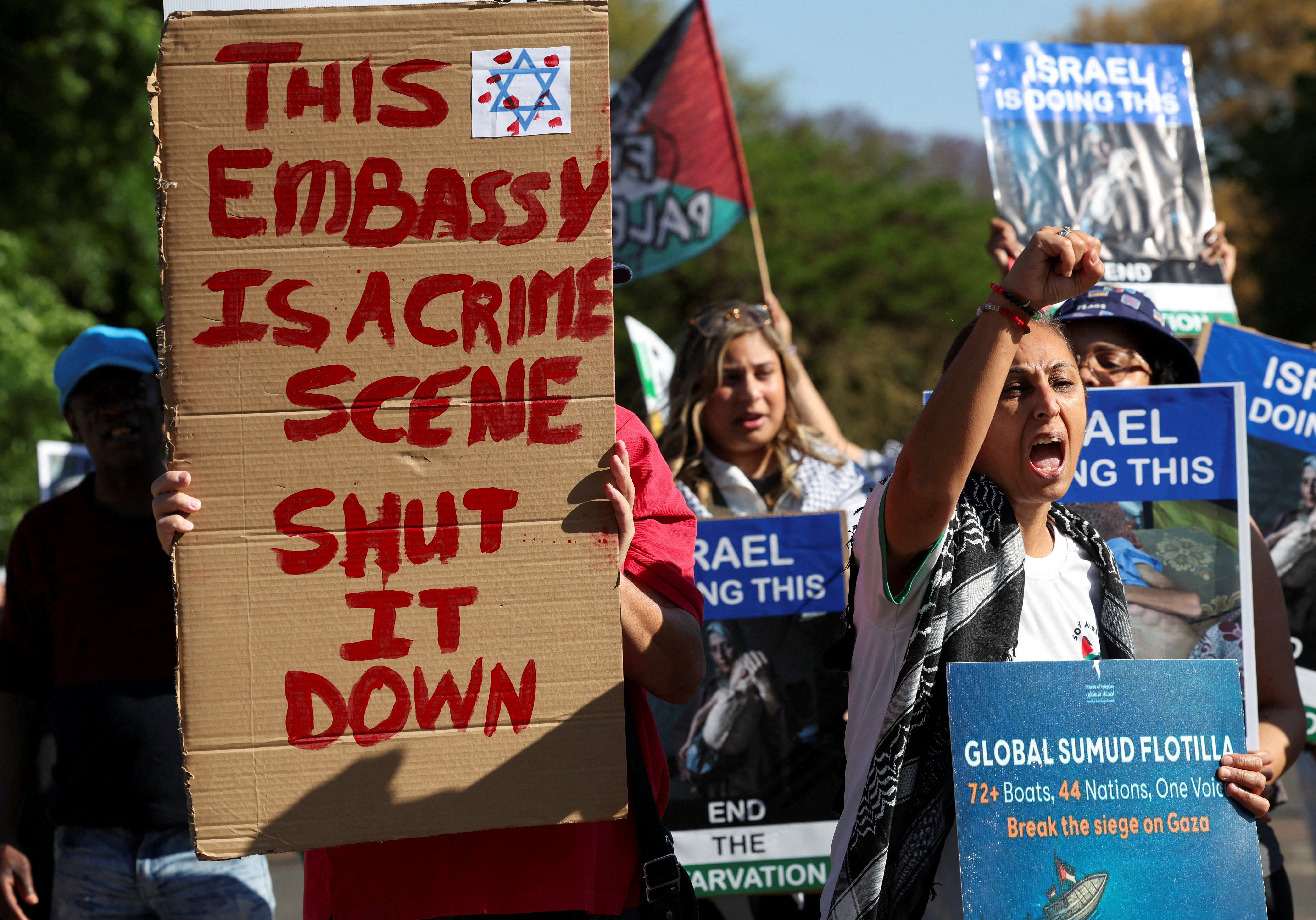 FILE PHOTO: Activists hold placards and shout slogans outside Israel's embassy as they protest the detention of members of a Gaza-bound aid flotilla, in Pretoria, South Africa, October 3, 2025. REUTERS/Esa Alexander/File Photo
