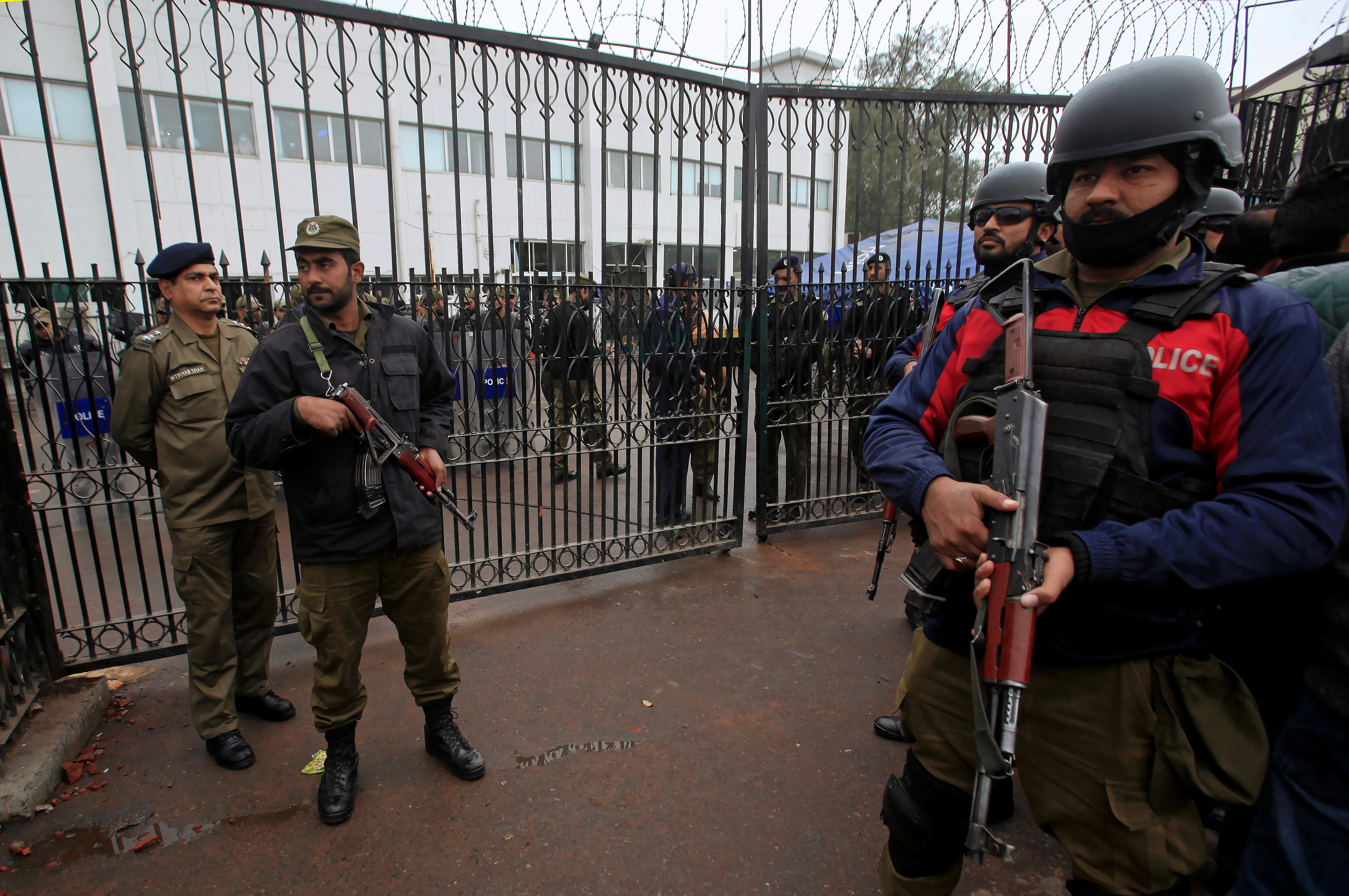 Police officers stand guard for security measures at the premises of the Punjab Institute of Cardiology (PIC) building, which was stormed by a group of lawyers the day before, in Lahore, Pakistan December 12, 2019. REUTERS/Mohsin Raza