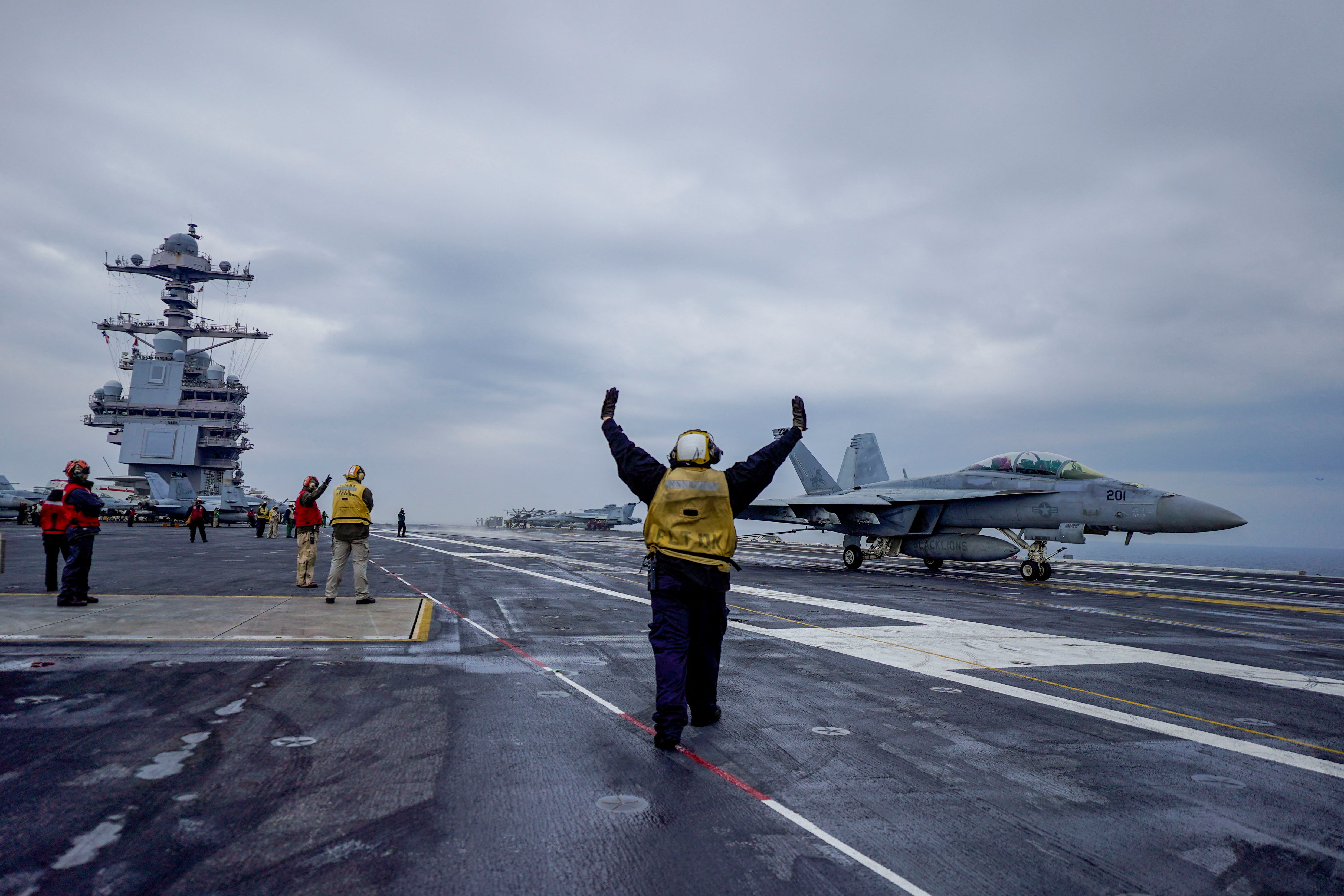 People stand onboard the American aircraft carrier USS Gerald R. Ford in the North Sea off Denmark, May 22, 2023. Hakon Mosvold Larsen/NTB/via REUTERS ATTENTION EDITORS - THIS IMAGE WAS PROVIDED BY A THIRD PARTY. NORWAY OUT. NO COMMERCIAL OR EDITORIAL SALES IN NORWAY.