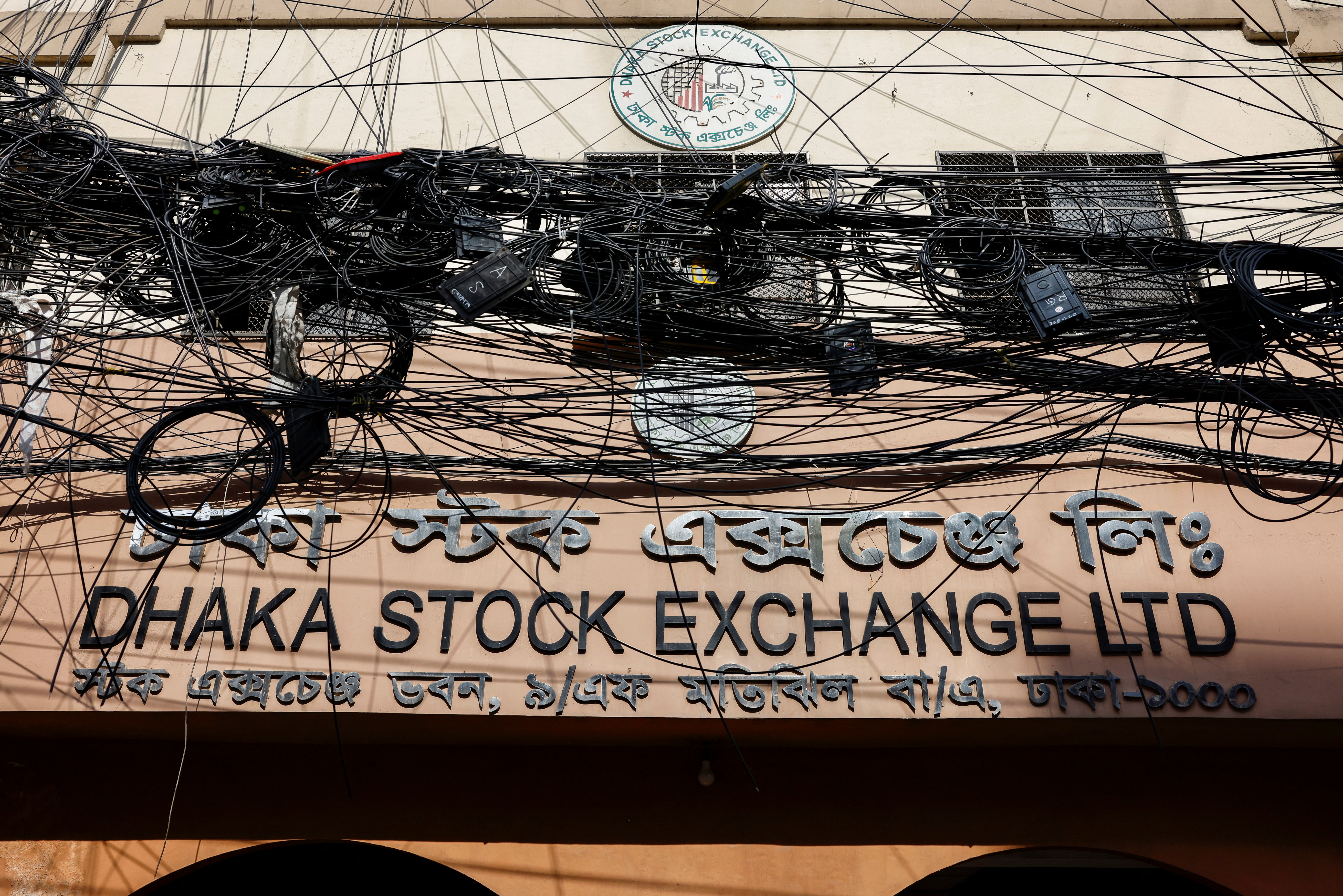 Tangled network cables are seen in front of the Dhaka Stock Exchange Limited building in Dhaka, Bangladesh, July 19, 2023. REUTERS/Mohammad Ponir Hossain