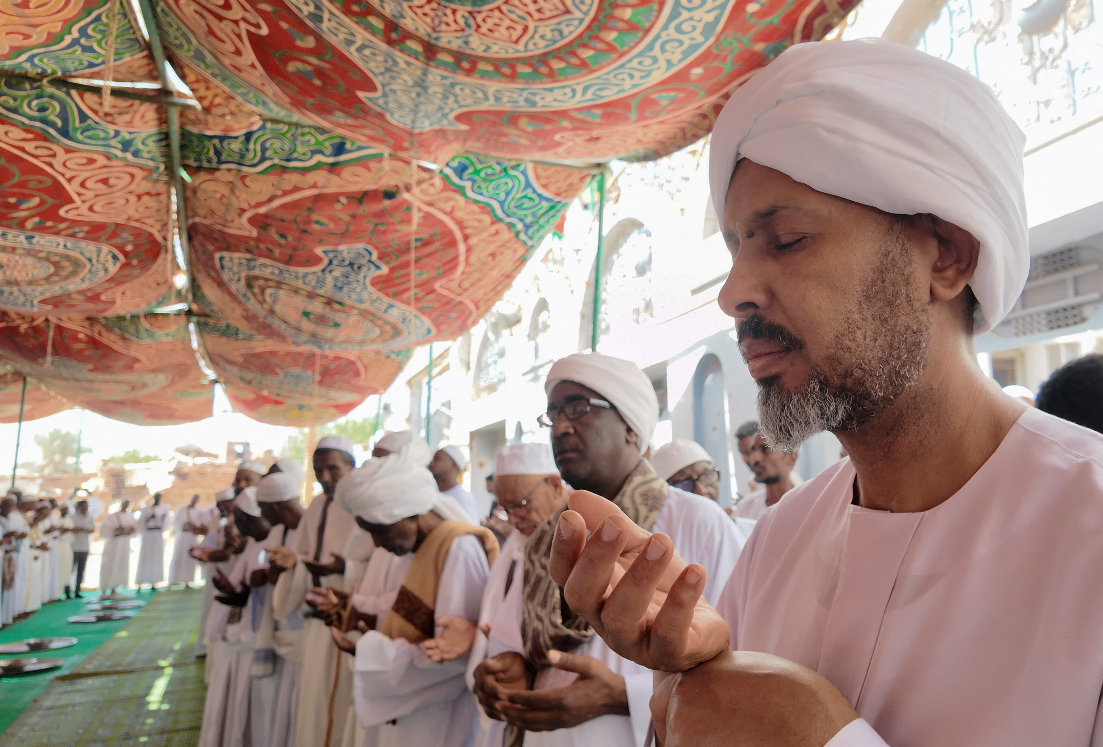 Sammaniya Sufi Sudanese Muslim worshippers perform hymns after Eid prayers in Omdurman, after the Sudanese army deepened its control over the capital Khartoum, from the Rapid Support Forces (RSF), in Sudan March 30, 2025. [El Tayeb Siddig/Reuters]
