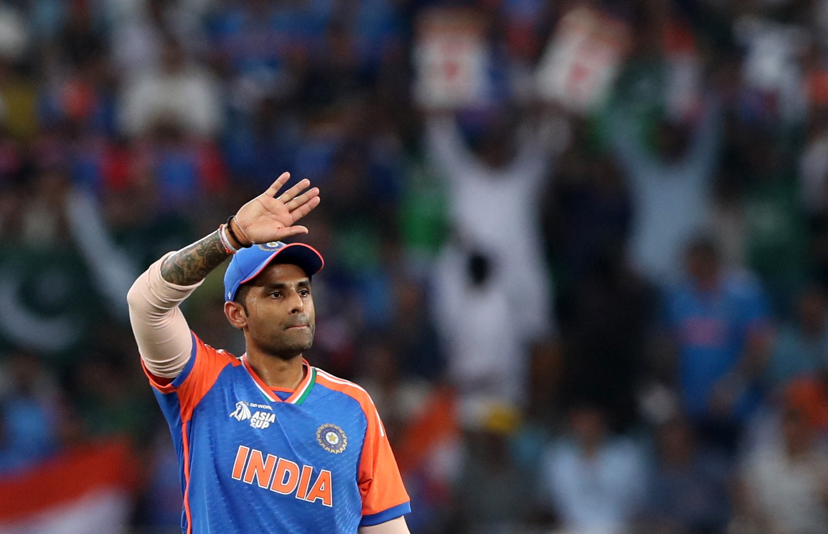 India's Suryakumar Yadav raises his hand on the field.