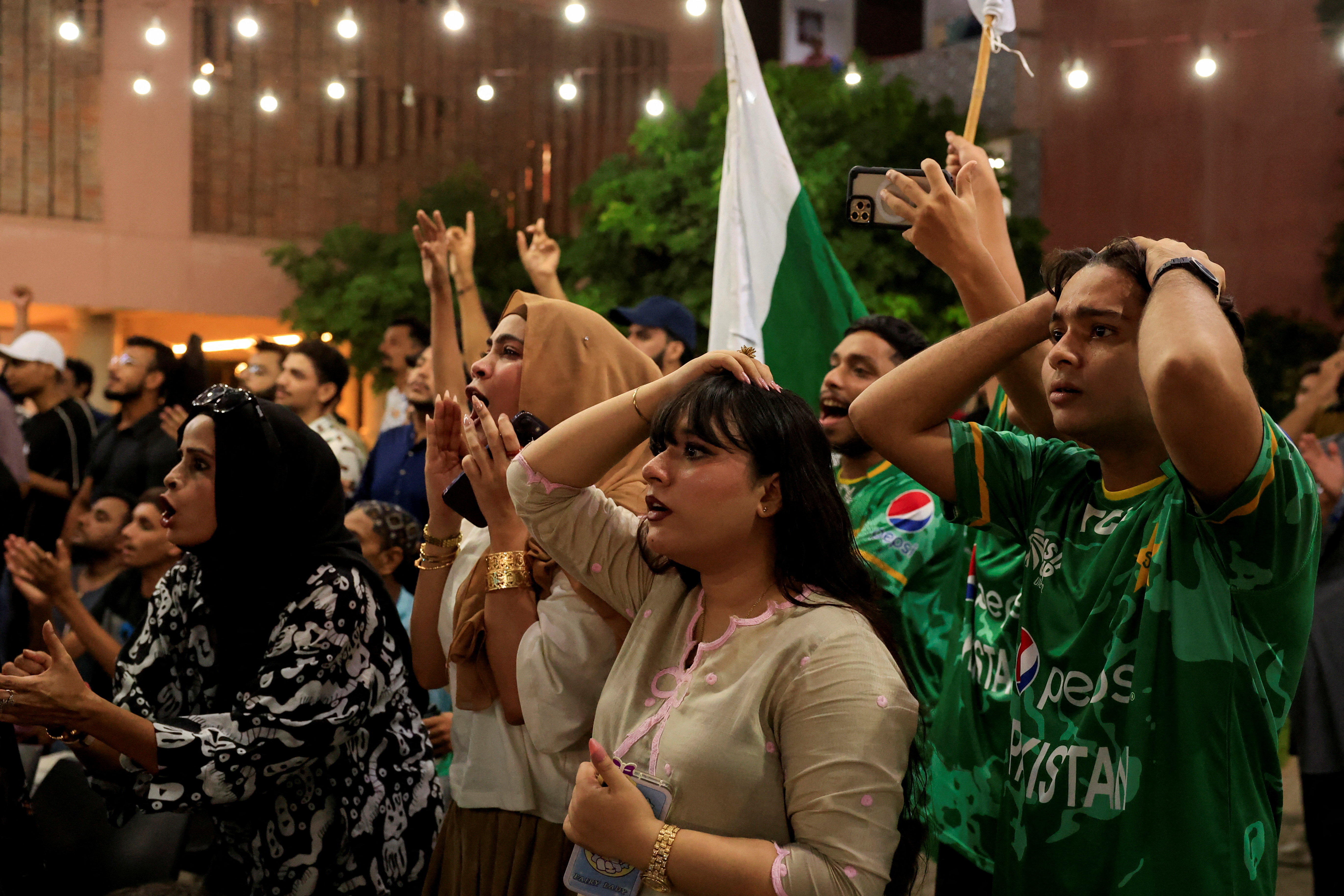 Pakistani fans react as they watch the final cricket match of Asia Cup between India and Pakistan on a screen, in Karachi, Pakistan, September 28, 2025. REUTERS/Akhtar Soomro