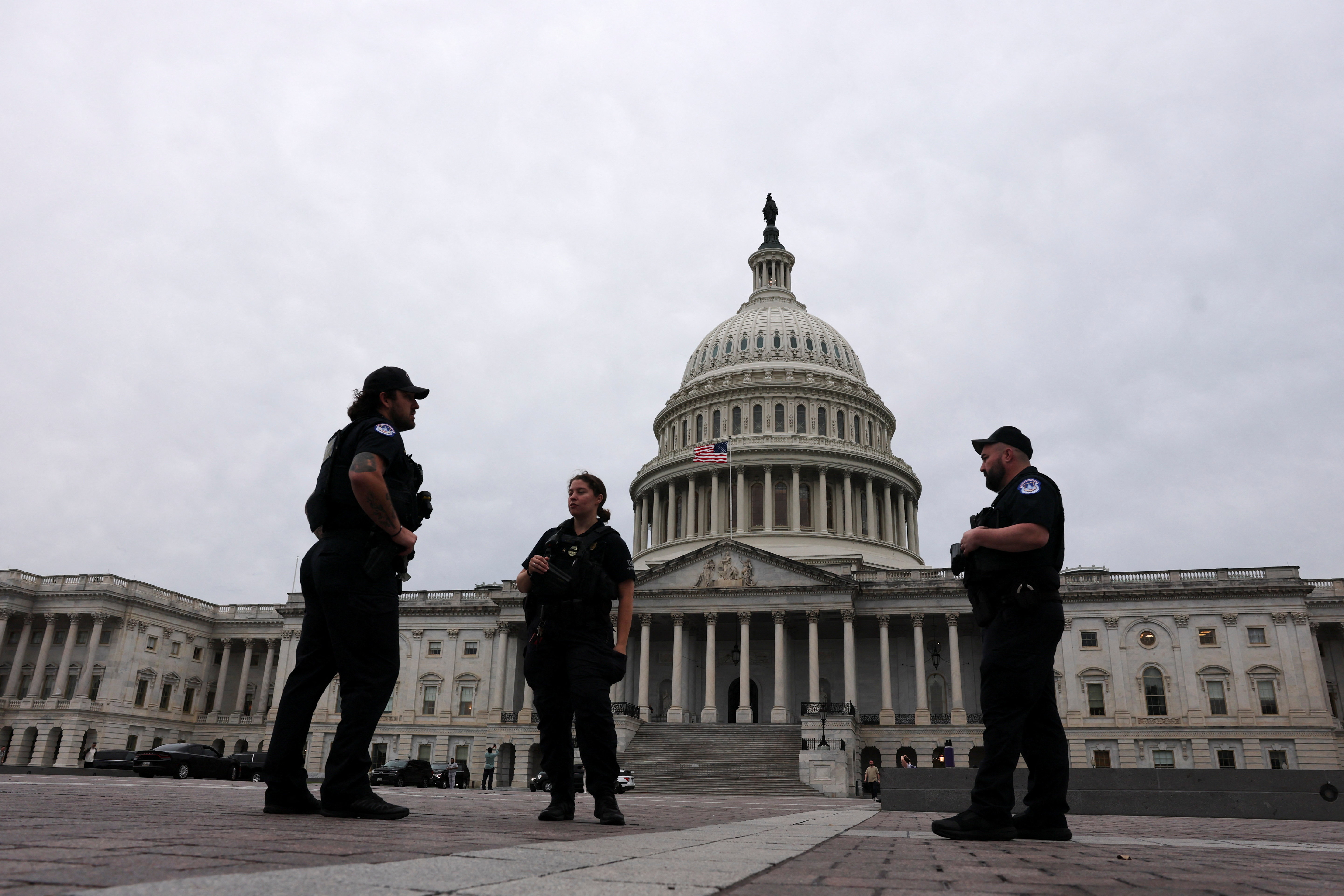 U.S. Capitol Police officers stand outside the Capitol dome as Senators vote, hours before a partial government shutdown is set to take effect on Capitol Hill in Washington, D.C., U.S., September 30, 2025. REUTERS/Jonathan Ernst