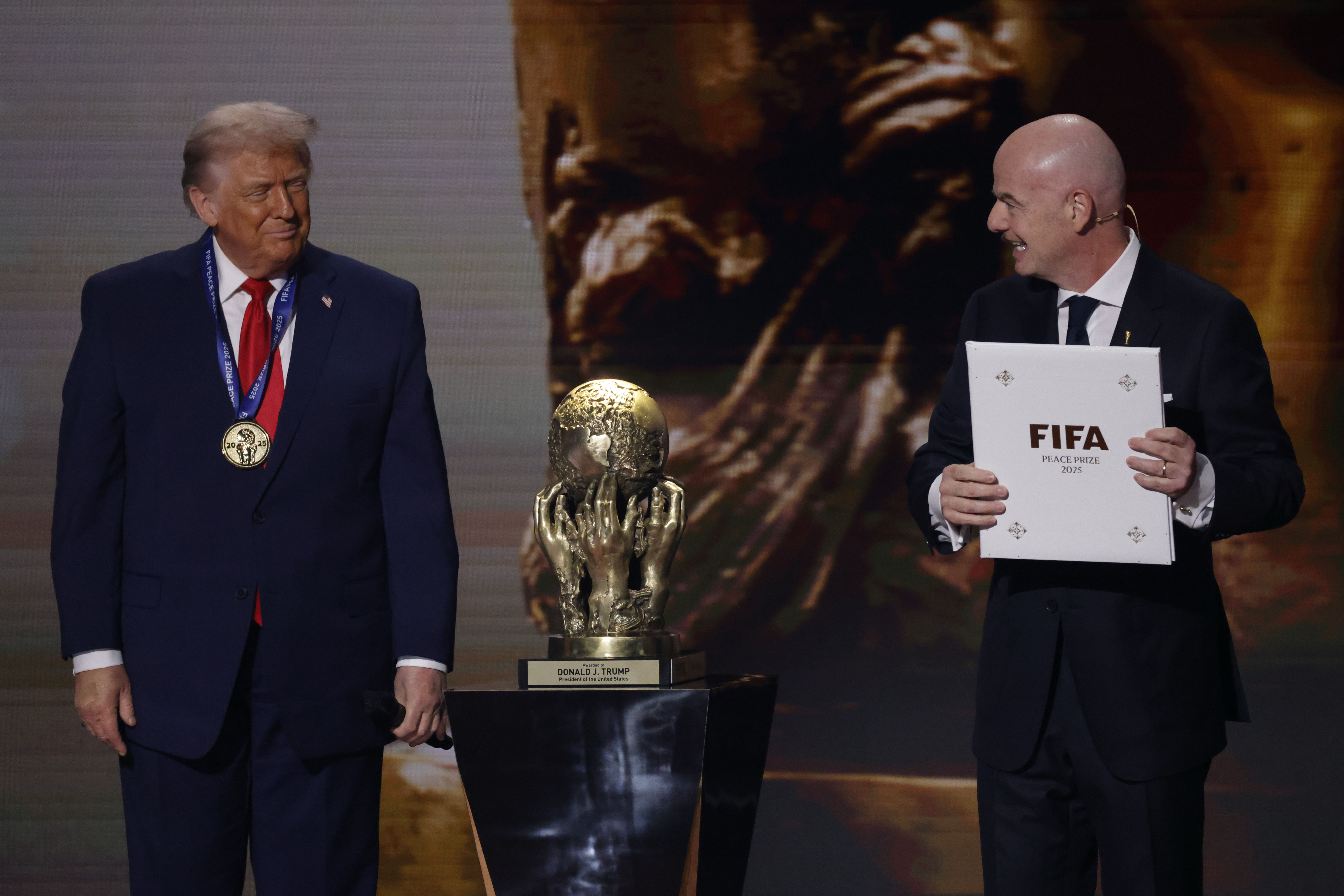 US President Donald Trump (L) receives the FIFA Peace Prize from FIFA President Gianni Infantino.