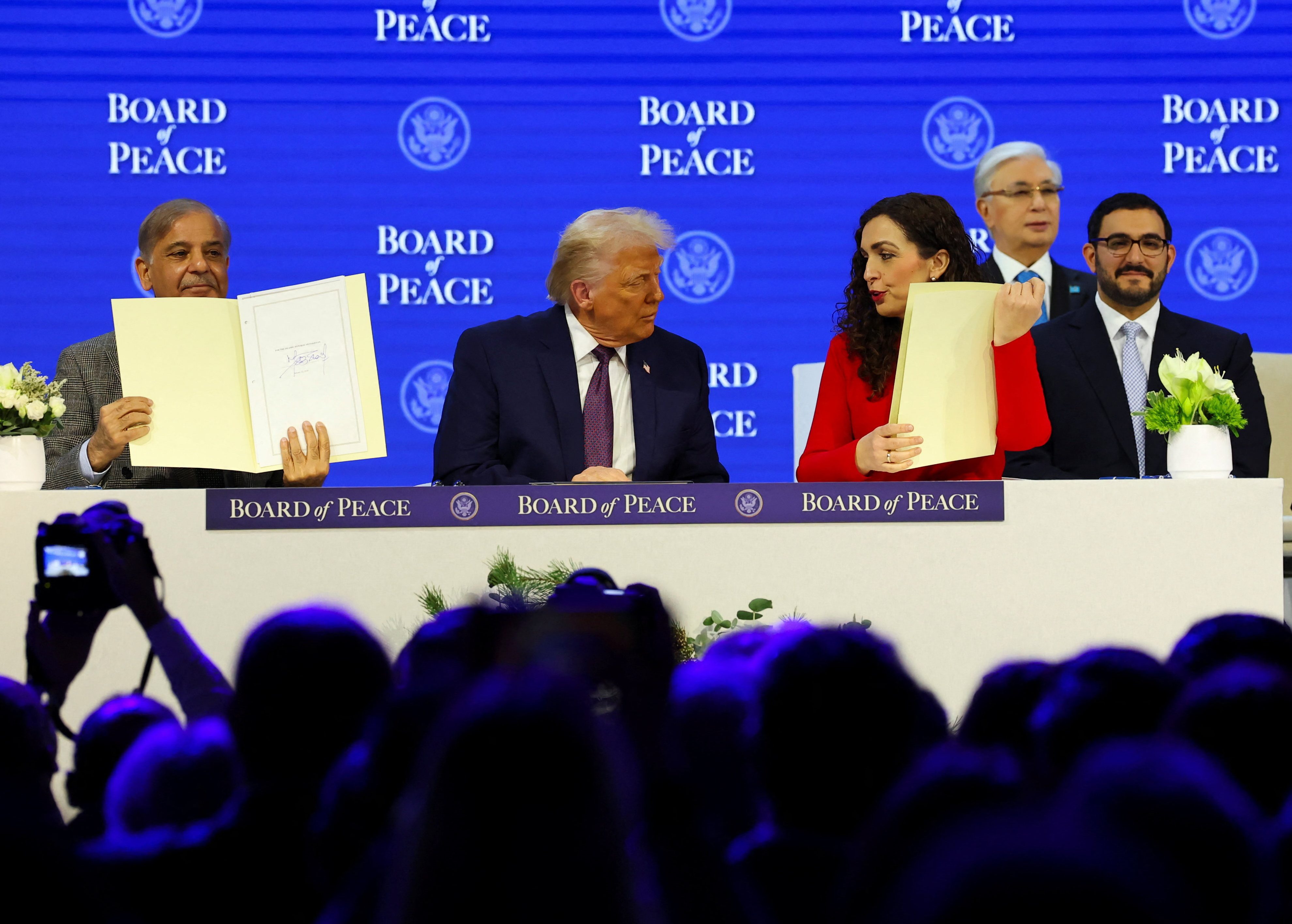 Pakistan's Prime Minister Shehbaz Sharif and President of Kosovo Vjosa Osmani hold signed Charter of the Board of Peace next to U.S. President Donald Trump, as they take part in a charter announcement for his Board of Peace initiative aimed at resolving global conflicts, alongside the 56th annual World Economic Forum (WEF), in Davos, Switzerland, January 22, 2026. REUTERS/Denis Balibouse