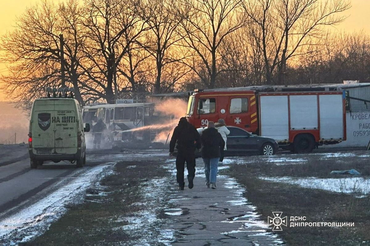 Emergency services personnel work at the site of what the Dnipropetrovsk governor said was an attack that killed 12 people and wounded 7, after a Russian drone struck near a bus in the Dnipropetrovsk region, in this handout picture released February 1, 2026, with location given as Ternivka, Dnipropetrovsk region, Ukraine