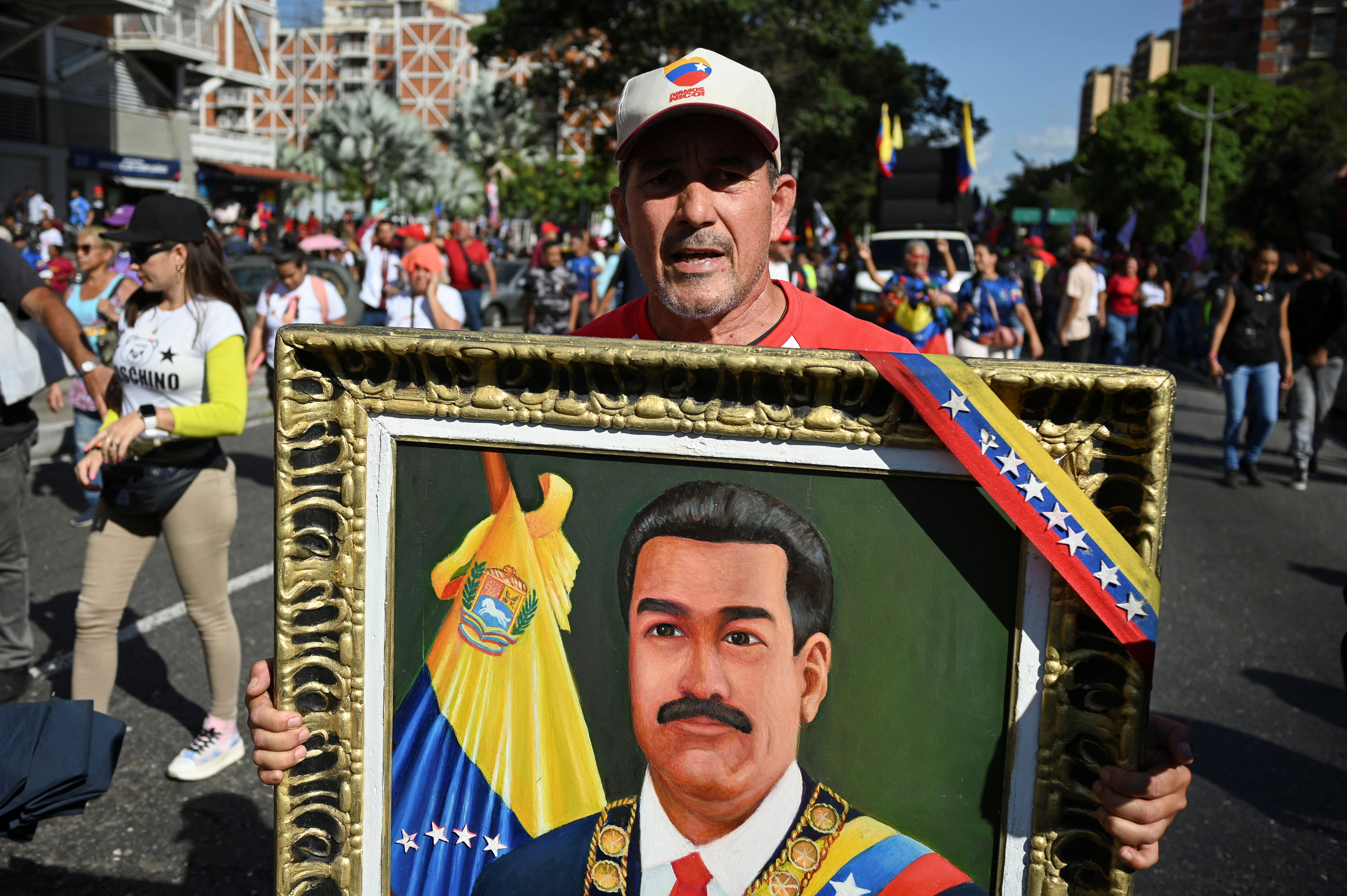 A supporter of Venezuela's government holds a portrait depicting ousted Venezuelan President Nicolas Maduro as he attends a rally to demand the release of Maduro and his wife, Cilia Flores, one month after their capture by the U.S. during recent U.S. strikes on the country, in Caracas, Venezuela, February 3, 2026. REUTERS/Maxwell Briceno