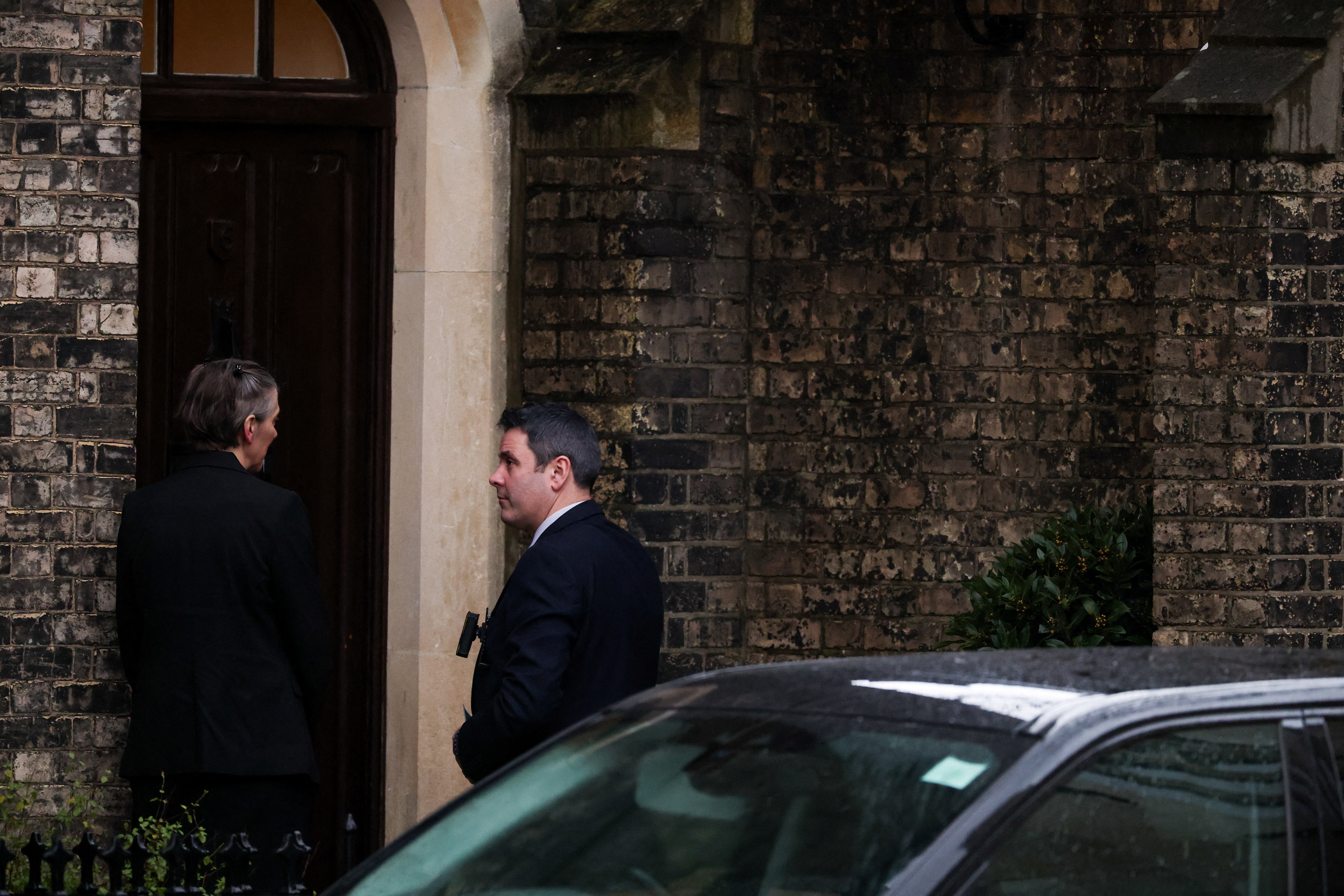 Police officers stand outside a reported residence of former British ambassador to the United States Peter Mandelson