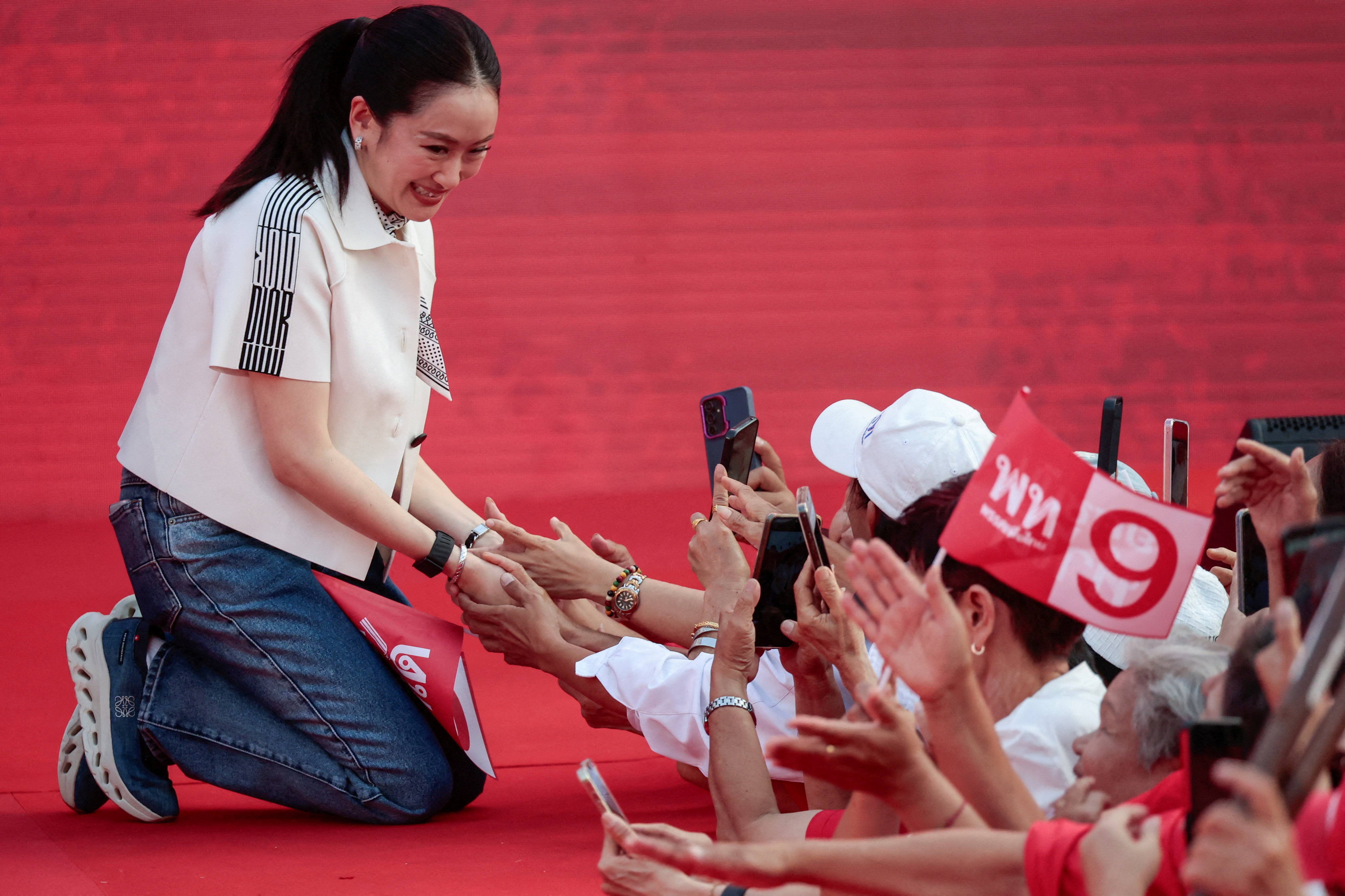 Former Prime Minister Paetongtarn Shinawatra shakes hands with Pheu Thai Party supporters during a major rally event ahead of the February 8 election, in Bangkok, Thailand, February 6, 2026. REUTERS/Patipat Janthong TPX IMAGES OF THE DAY
