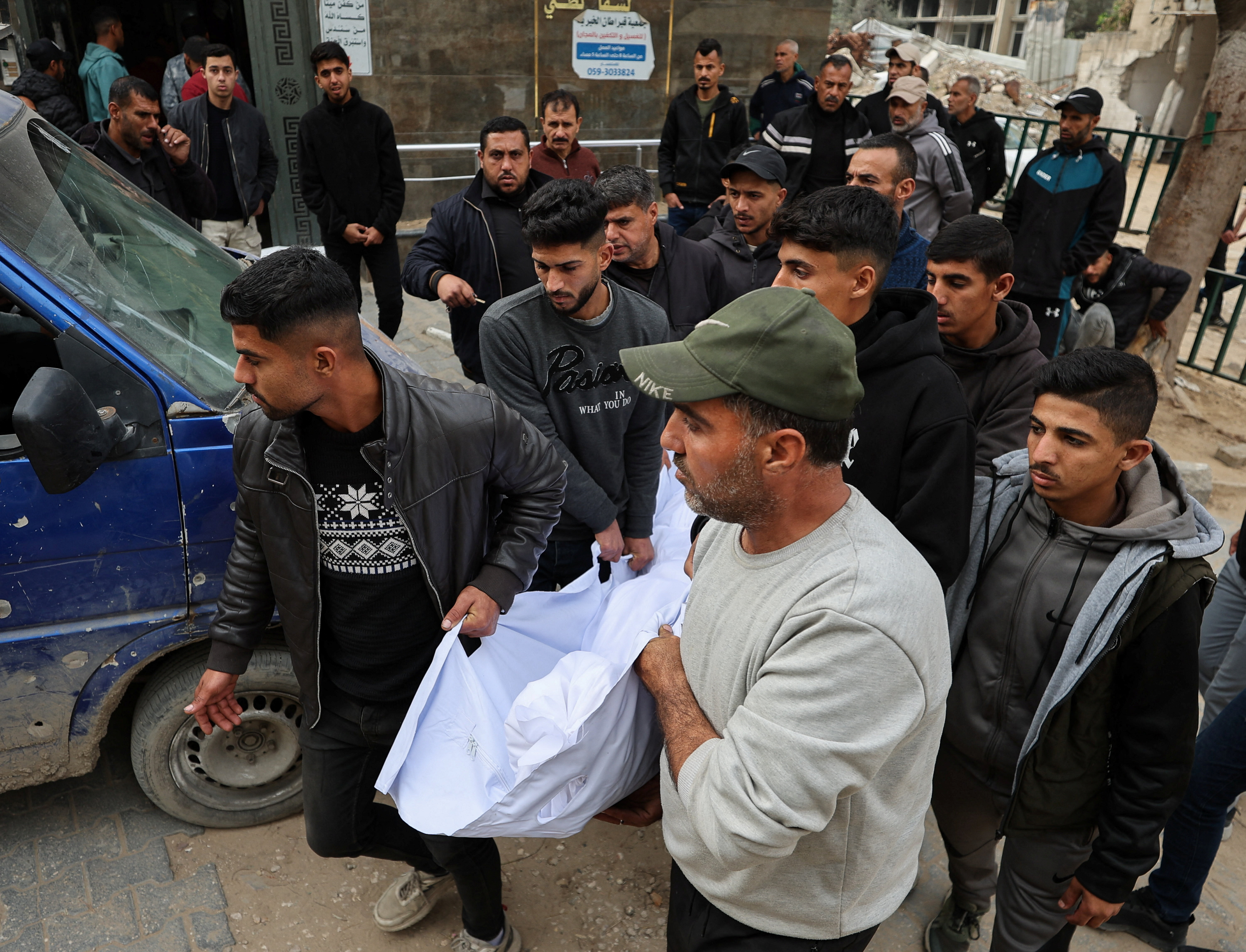 Mourners carry the body at the funeral of a Palestinian man.