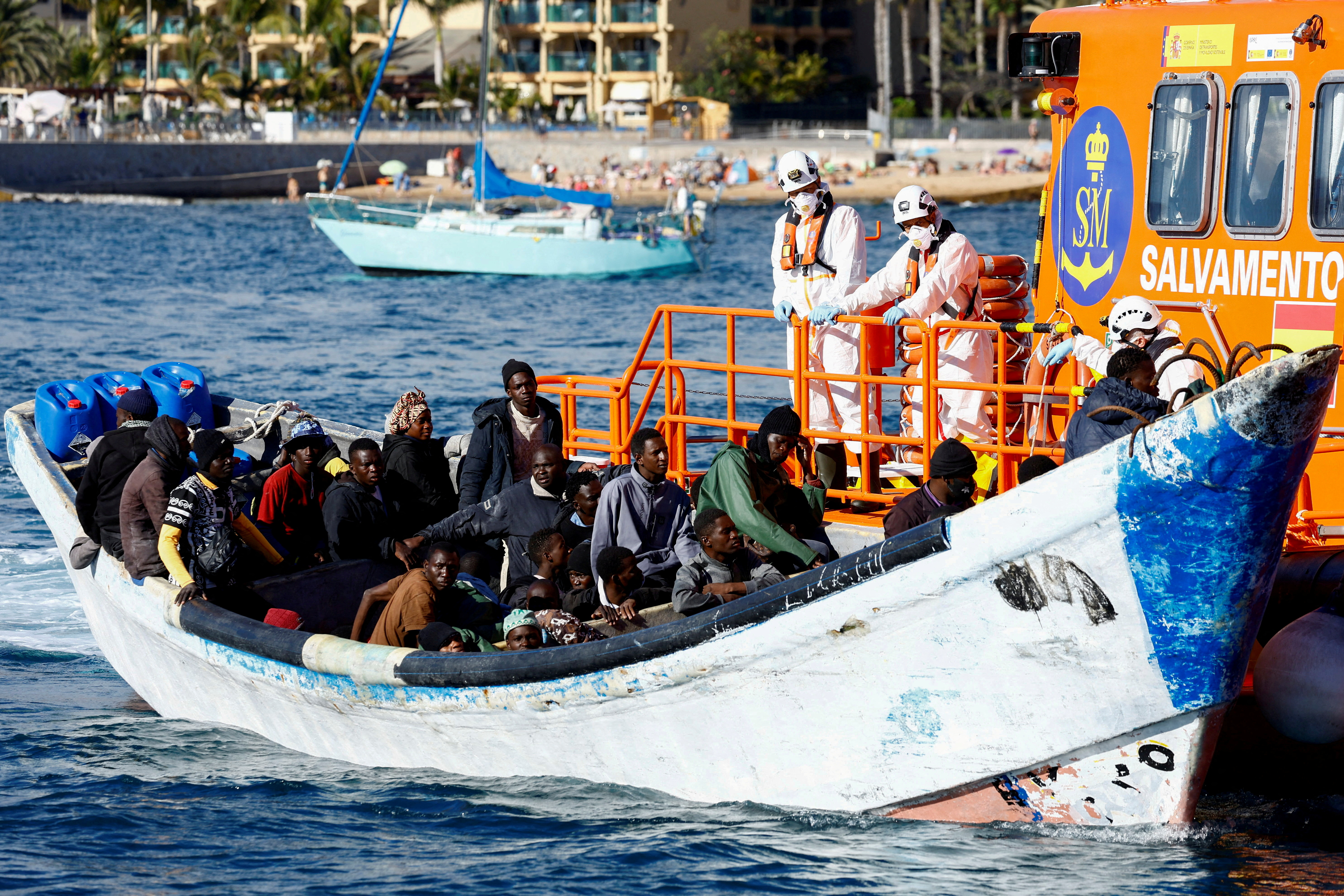 FILE PHOTO: A Spanish Coast Guard vessel tows a fibreglass boat with migrants onboard to the port of Arguineguin, on the island of Gran Canaria, Spain, March 5, 2025. REUTERS/Borja Suarez/File Photo/File Photo