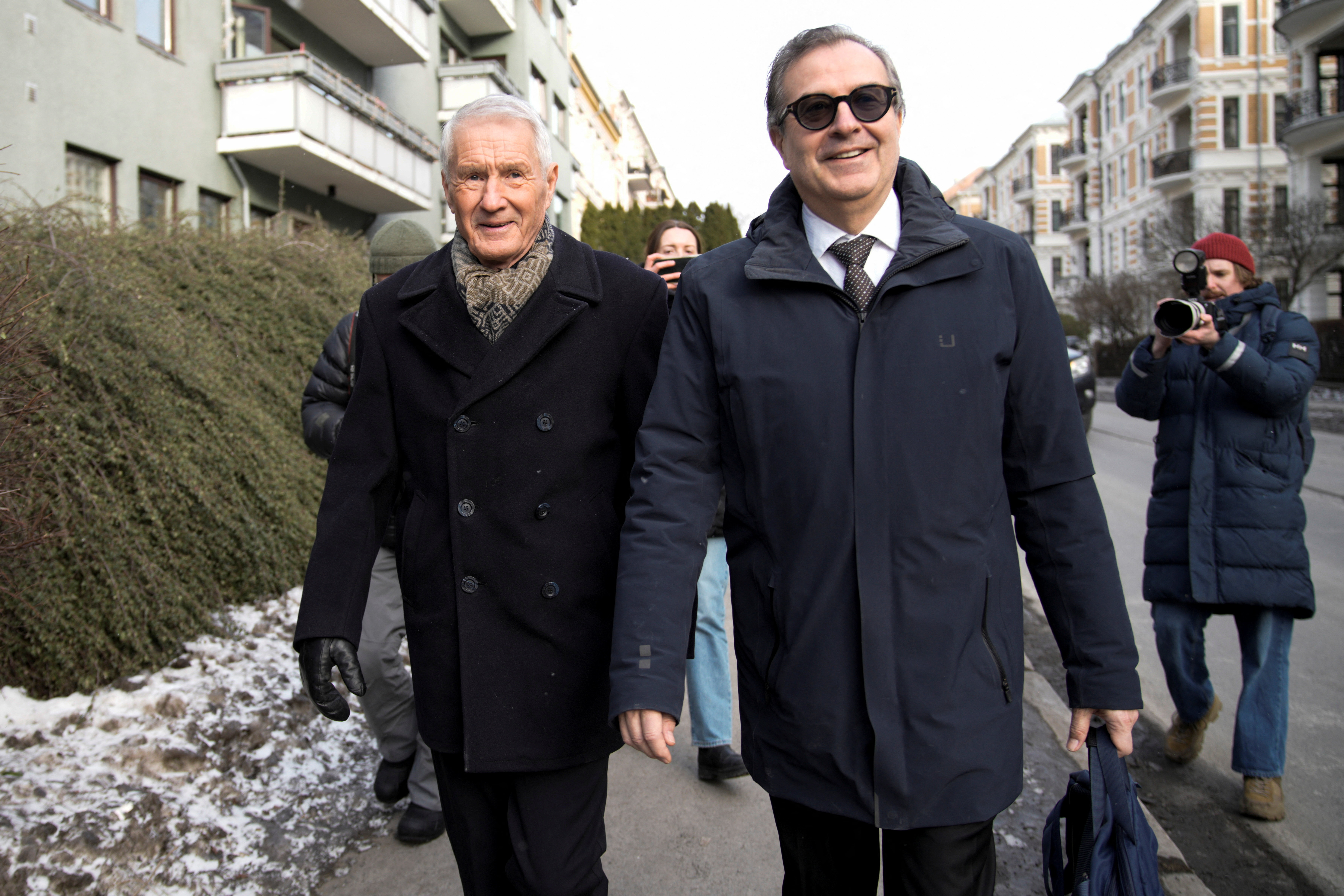 Members of the National Authority for Investigation and Prosecution of Economic and Environmental Crime search Thorbjorn Jagland's apartment building as he walks with his lawyer Anders Brosveet