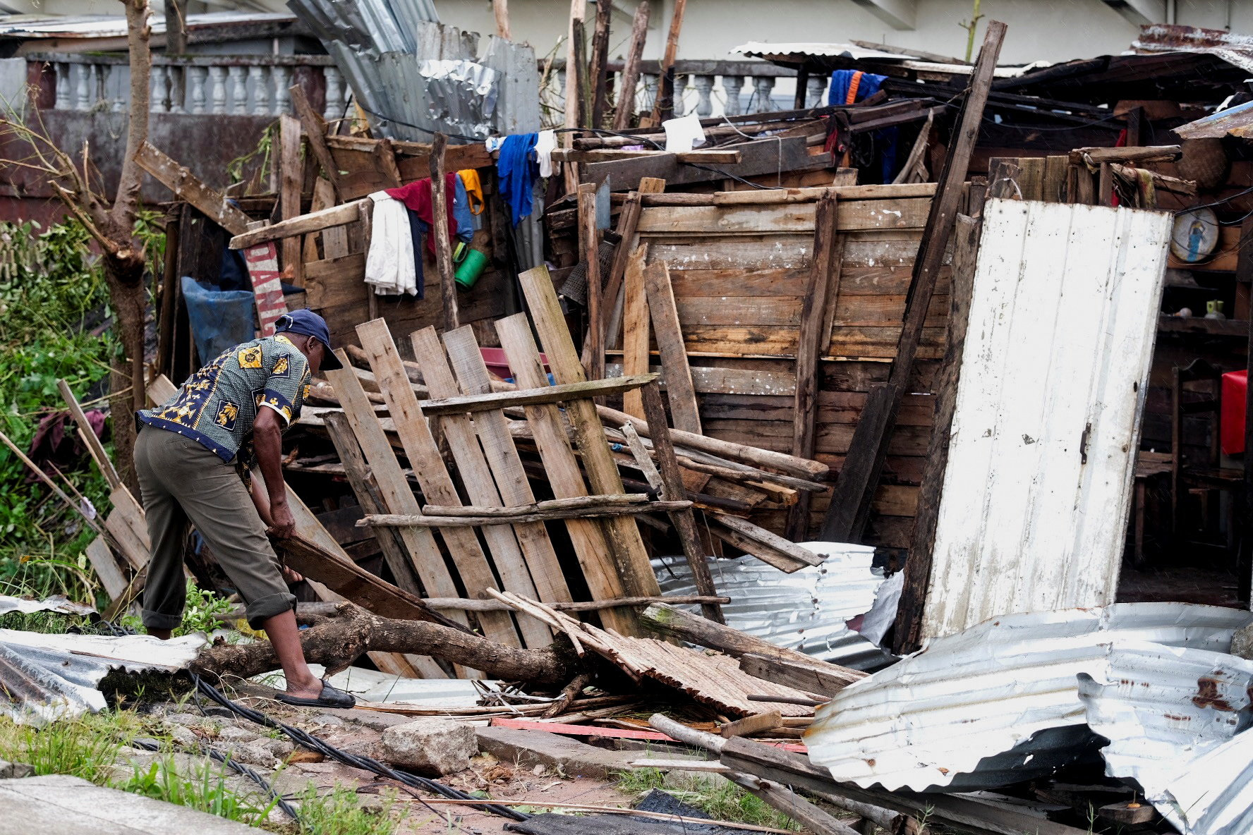 A man sorts his belongings after Cyclone Gezani tore through the port city of Toamasina, Madagascar, leaving a trail of destruction, February 12, 2026.