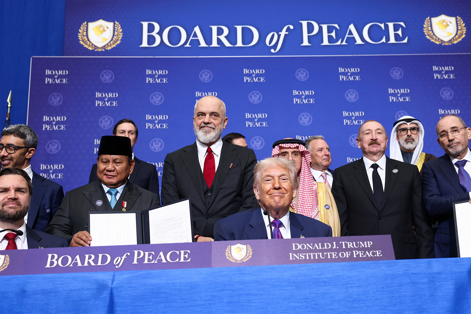U.S President Donald Trump, Vice President JD Vance, Albania's Prime Minister Edi Rama, Saudi Minister of State for Foreign Affairs, Cabinet Member, and Climate Envoy Adel Al-Jubeir, Azerbaijani President Ilham Aliyev, and Jordan's Foreign Minister Ayman Safadi present signed documents of the declaration of the funding donors to the Board of Peace, during the inaugural Board of Peace meeting at the U.S. Institute of Peace in Washington, D.C., U.S., February 19, 2026. [FILE: Kevin Lamarque/Reuters]