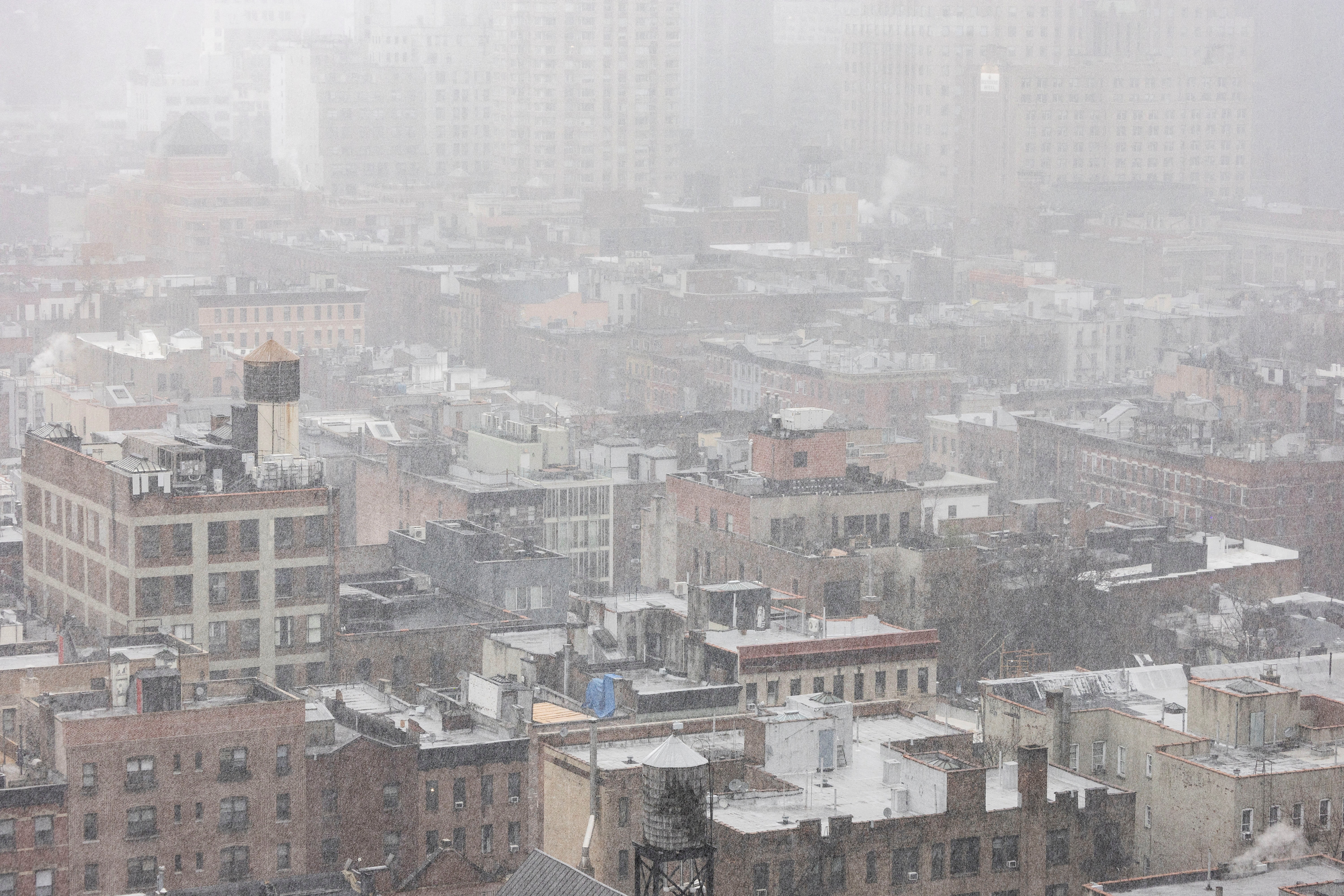 Snow covers residential buildings during a winter storm in the Brooklyn Borough