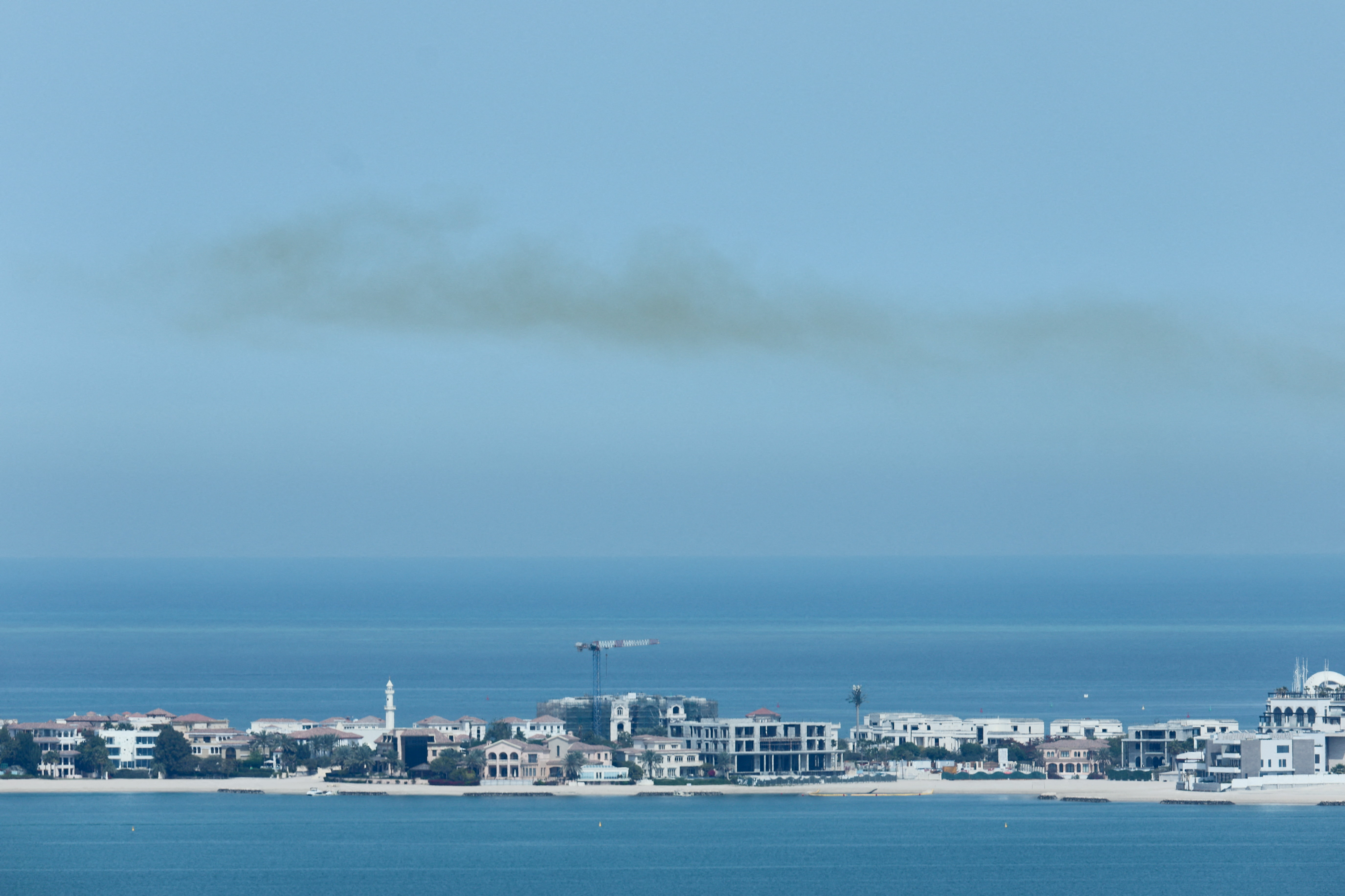 Smoke is left in the sky after blasts were heard in Doha, Qatar