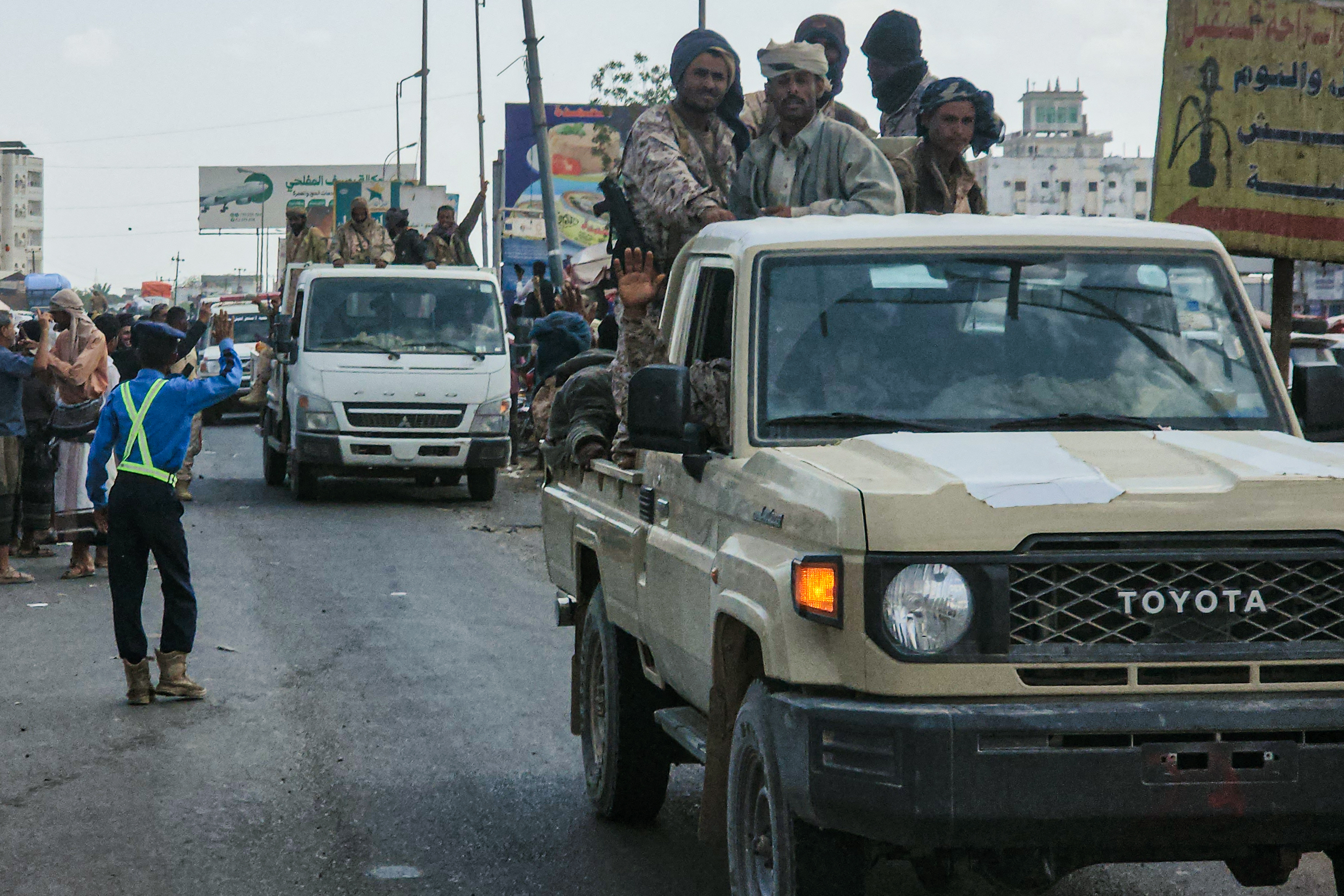 Fighters said to be backed by the Saudi-led coalition drive through the streets of the port city of Aden on January 8, 2026, the day after it was annouced that Yemen's separatist leader had fled to the United Arab Emirates. A Saudi-led coalition struck the home province of Yemen's UAE-backed separatist Southern Transitional Council (STC) leader on January 7, 2026, after he failed to show up for talks in Saudi Arabia, kicking him out of Yemen's Presidential Leadership Council and accusing him of high treason, while the Saudi coalition bombed his home province after he refused to attend talks in Riyadh. (Photo by SALEH AL-OBEIDI / AFP)