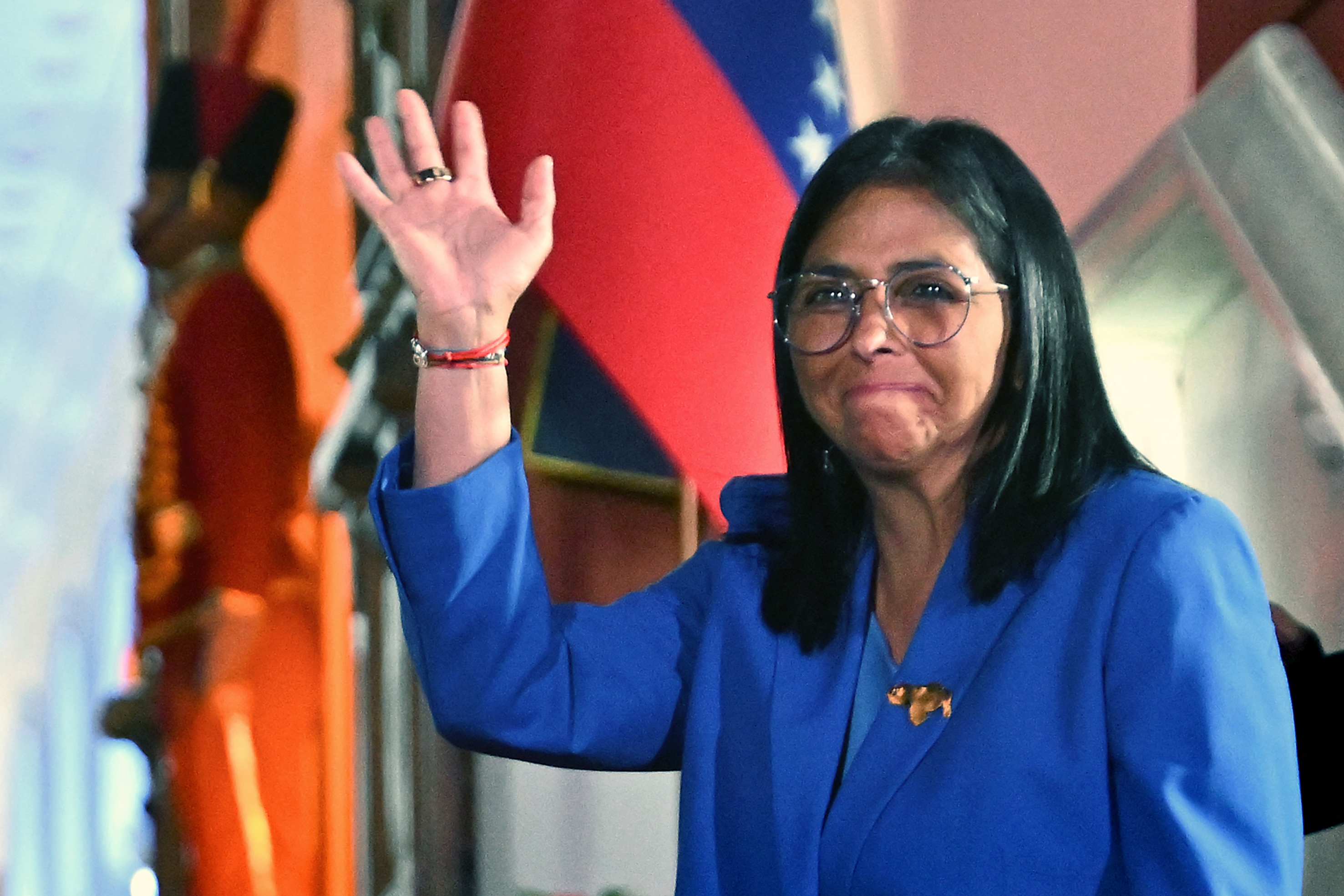 Venezuela's interim president Delcy Rodriguez waves after signing the amnesty law approved by the National Assembly at the Miraflores Palace in Caracas on February 19, 2026.