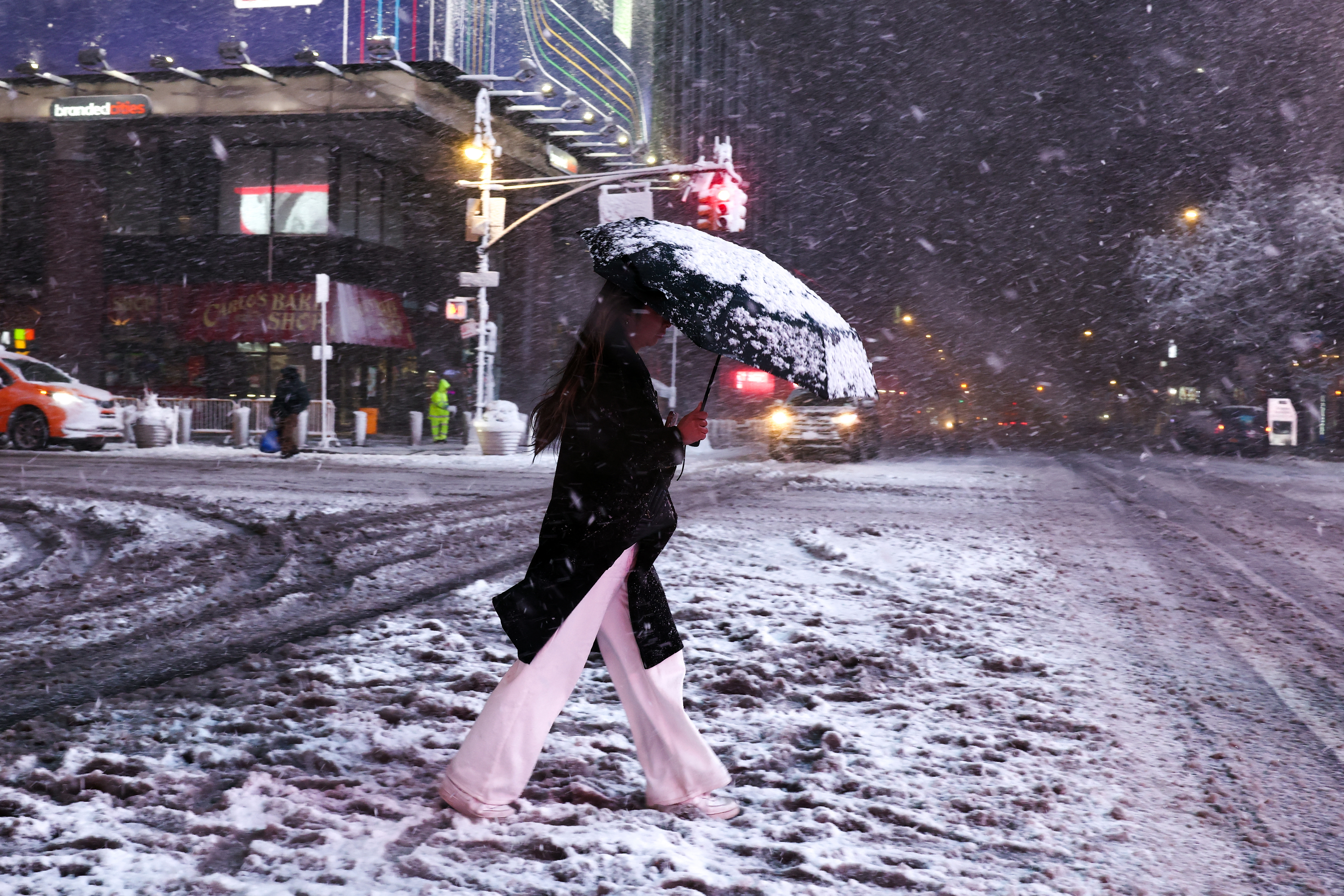 A woman crosses Manhattan's 8th Avenue