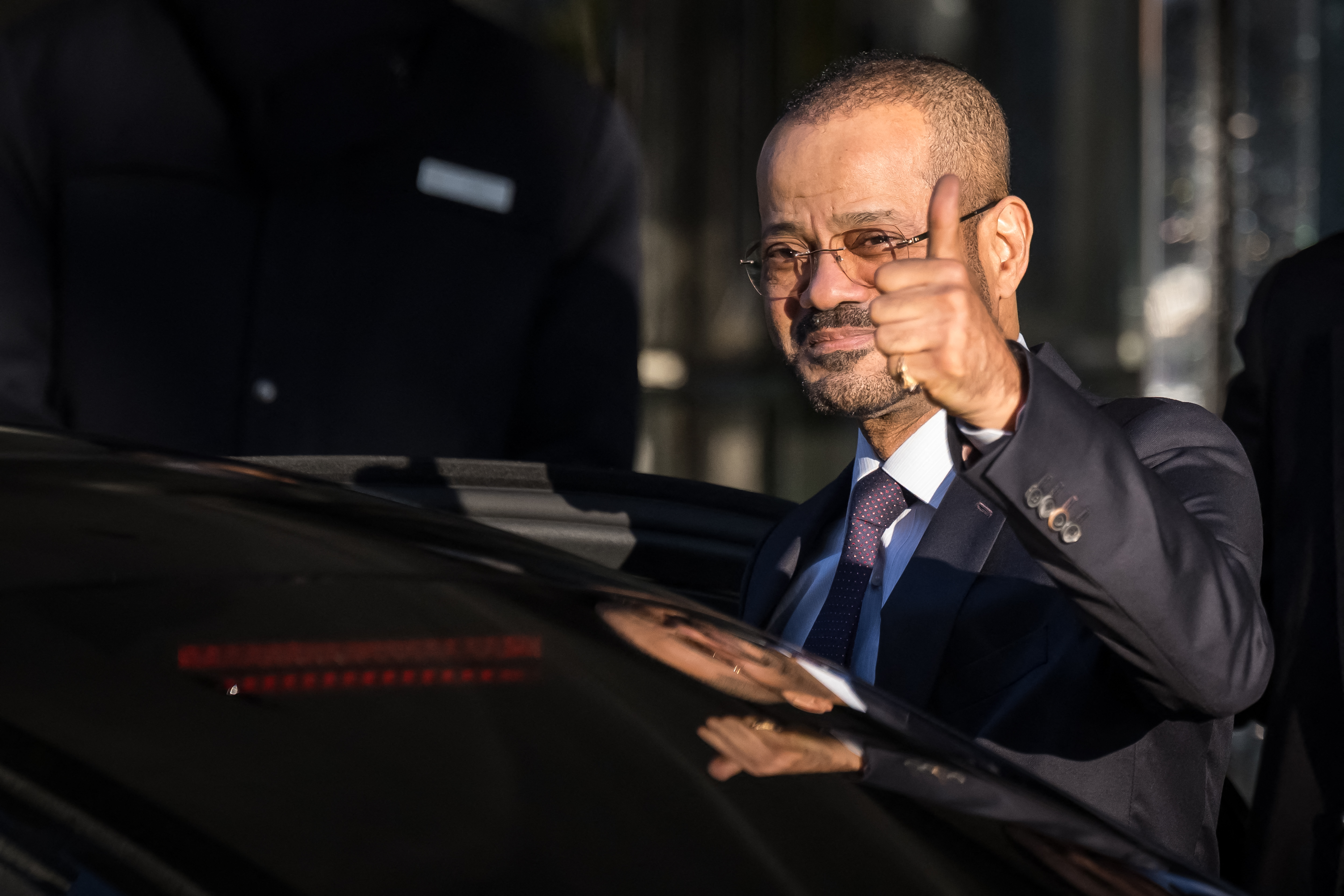 Oman's Foreign Affairs' Minister Badr bin Hamad al-Busaidi gives a thumbs up as he leaves his hotel to reach Oman's ambassador residency for new round of talks between the United States and Iran to address Iran's nuclear program, in Geneva on February 26, 2026. (Photo by Fabrice COFFRINI / AFP)