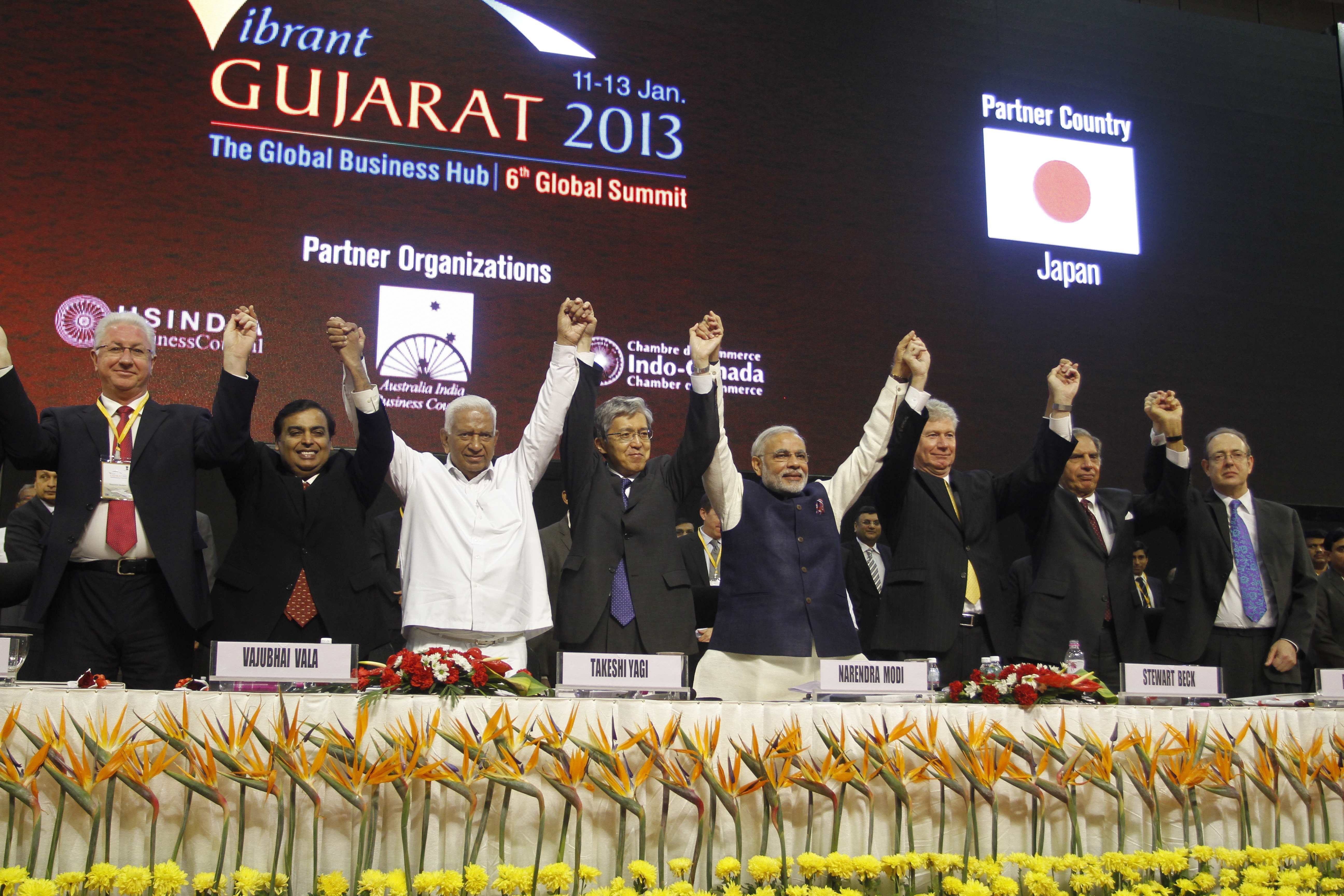 FILE - In this Jan. 11, 2013 file photo, then-Gujarat Chief Minister Narendra Modi, fourth from right, Japanese Ambassador to India Takeshi Yagi, fourth from left, and other participants raise their hands as they pose for photos during the inauguration of the 6th Vibrant Gujarat Global Summit (VGGS) in Gandhinagar, India. Vibrant Gujarat Global Summit is a biennial gathering for discussion and action on emerging business opportunities in Gujarat and beyond. Modi, who is now India's prime minister, will arrive in Japan Saturday, Aug. 30, 2014 for his five-day visit. So far, Japans investments have been concentrated mainly in Indias thriving pharmaceuticals sector and auto industry - Maruti-Suzuki, a subsidiary of Japans Suzuki Motor Corp., is Indias biggest carmaker. Others are: from left, Vice-Governor and Chairman of the Regional Government of Astrakhan of Russian Federation Konstantin Markelov, Reliance Industries Limited Chairman Mukesh Ambani, former Gujarat Finance Minister Vajubhai Vala, Yagi, Modi, Canadian High Commissioner to India Stewart Beck, retired Tata Group Chairman Ratan Tata and British High Commissioner to India James Bevan. (AP Photo/Ajit Solanki, File)