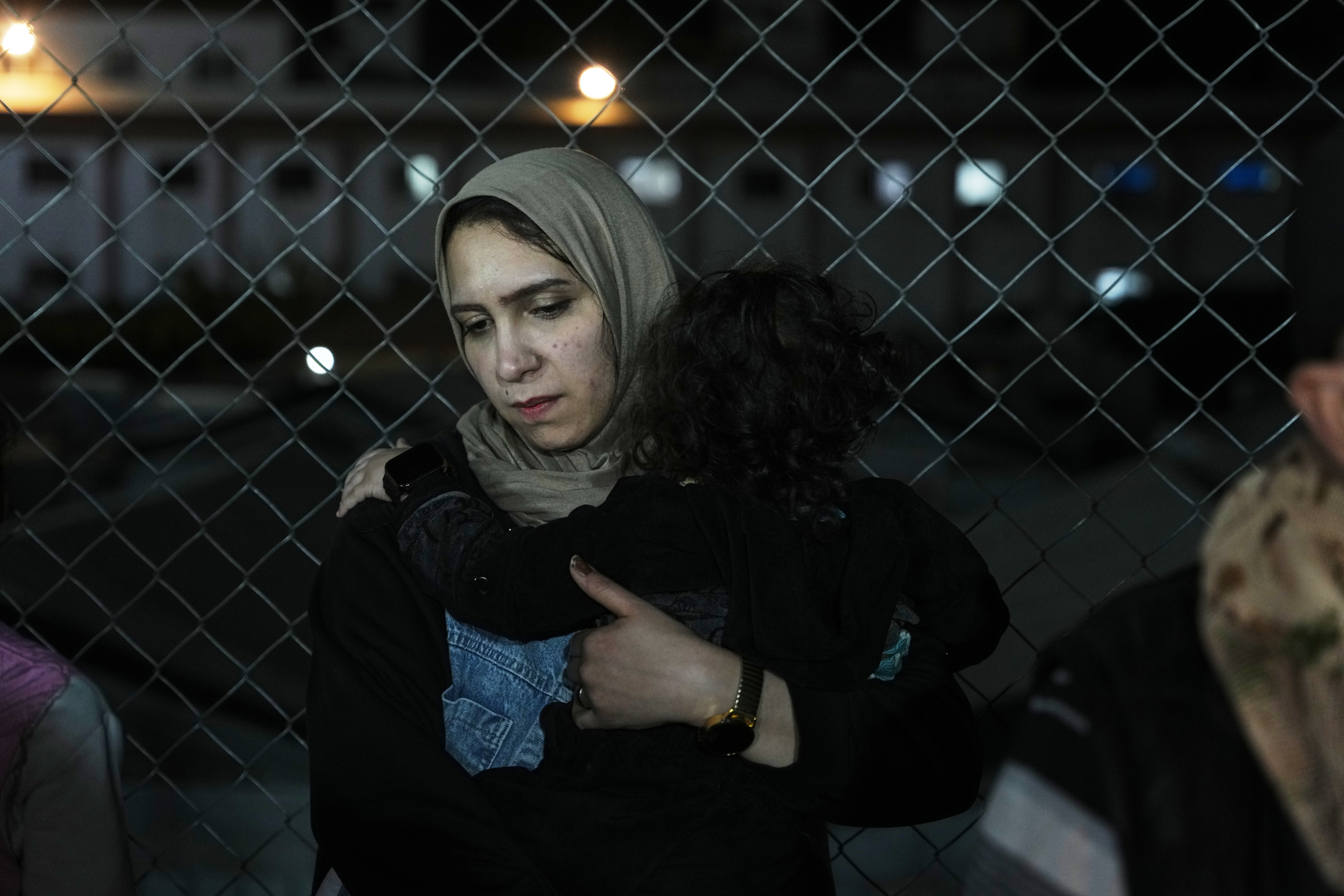 A woman and her children arrive at a hospital.