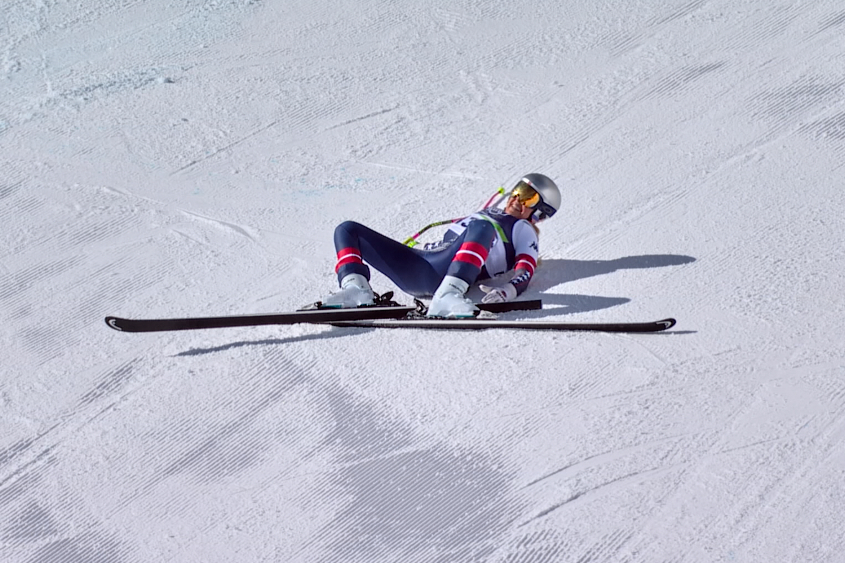 In this image taken from video provided by Olympic Broadcasting Services, OBS, United States' Lindsey Vonn lays on the course after crashing during an alpine ski women's downhill race, at the 2026 Winter Olympics