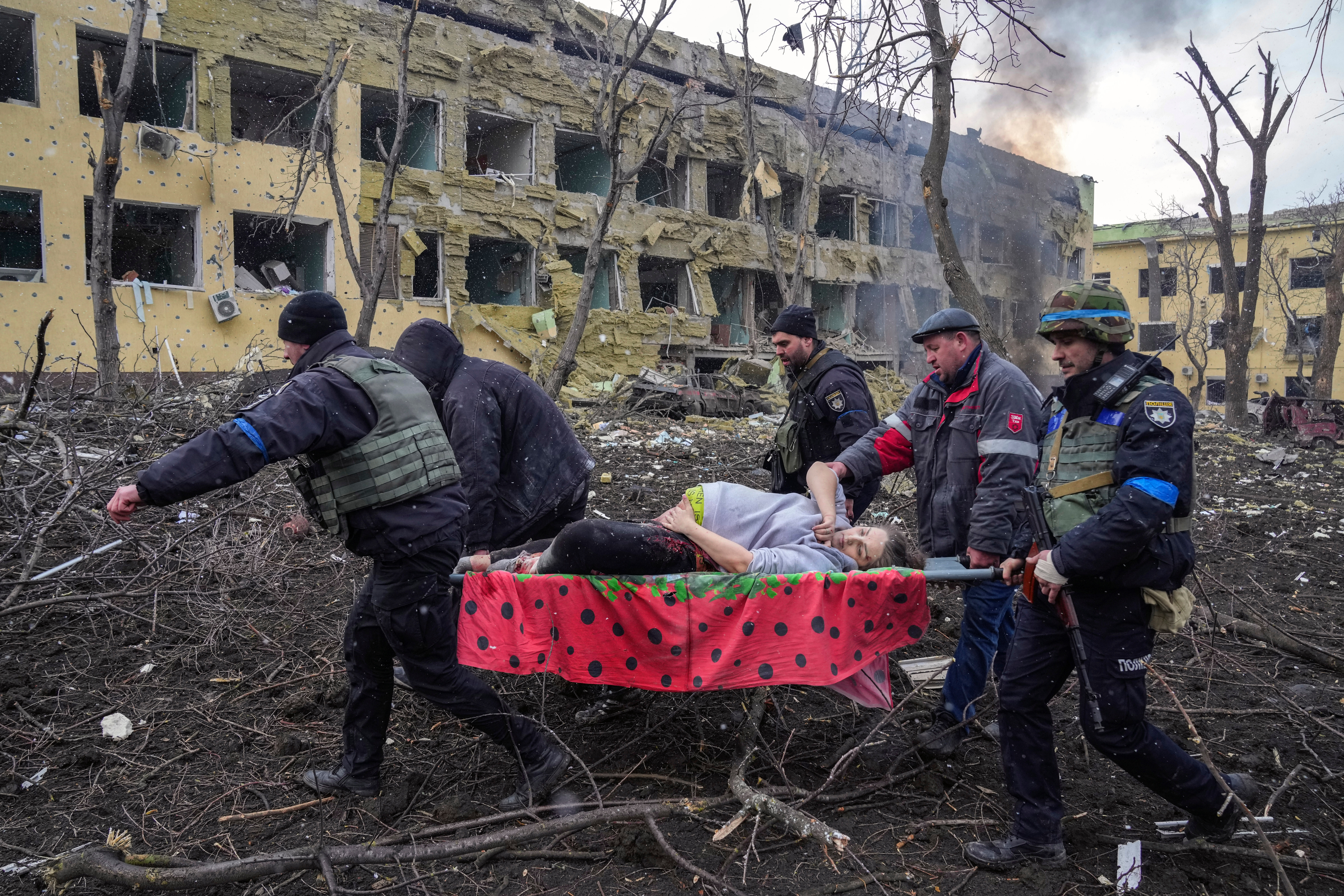 A pregnant woman who was severely wounded during Russian shelling is evacuated from a maternity hospital in Mariupol, Ukraine