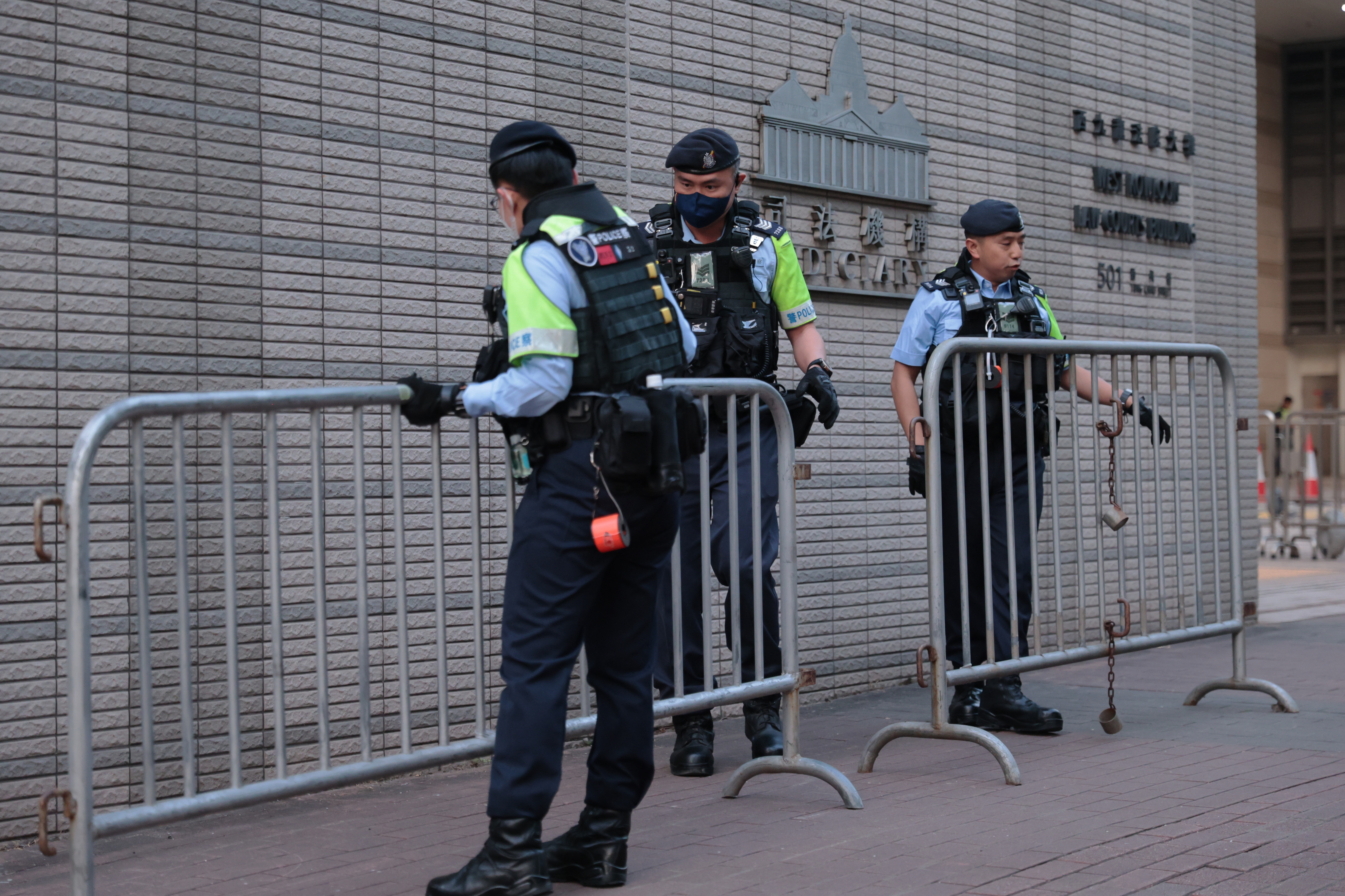 Police set up barricades outside West Kowloon Law Courts Building ahead of the national security appeal cases, in Hong Kong, Monday, Feb. 23, 2026. (AP Photo/May James)