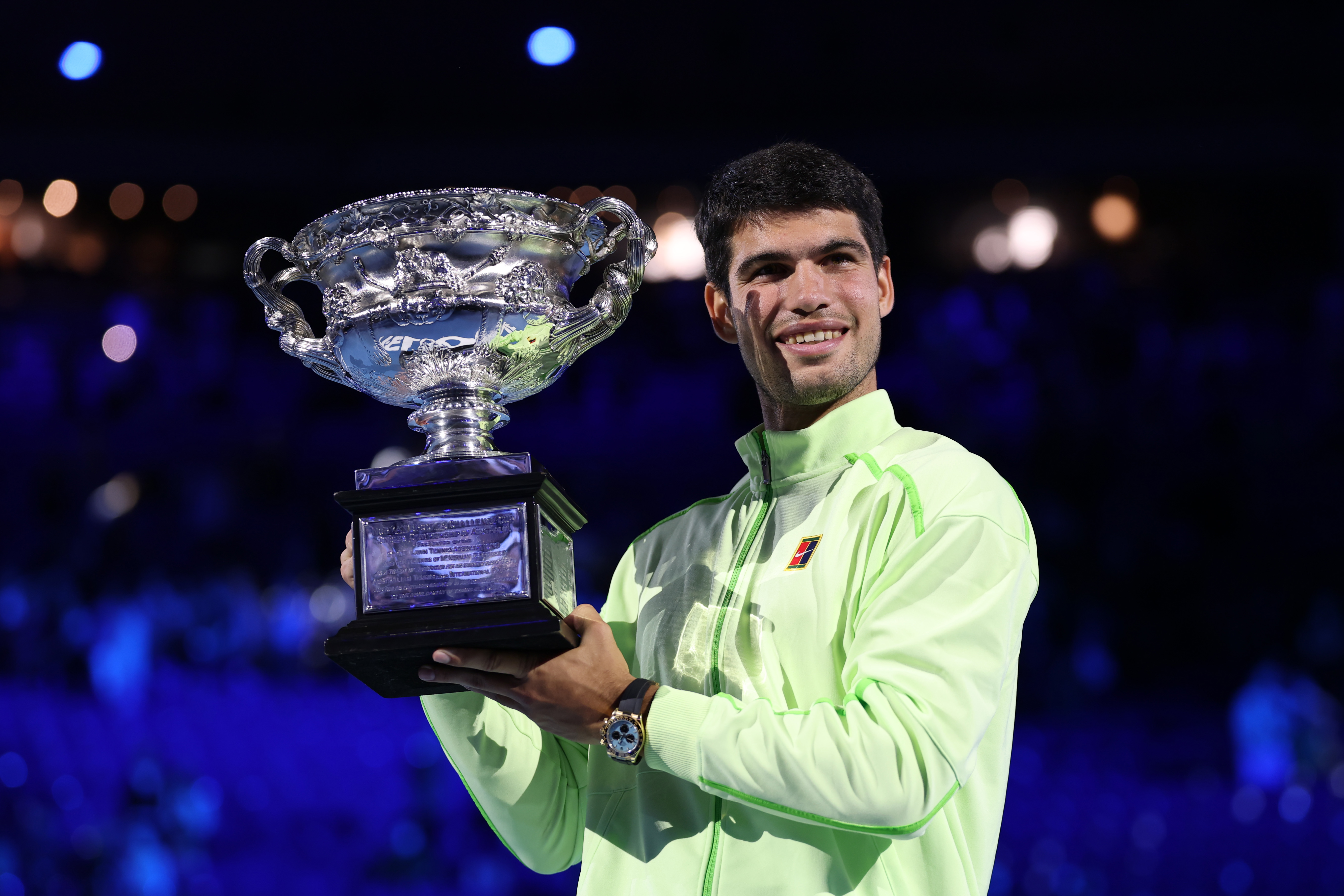MELBOURNE, AUSTRALIA - FEBRUARY 01: Carlos Alcaraz of Spain poses with the Norman Brookes Challenge Cup at the presentation ceremony after his victory in the Men's Singles Final against Novak Djokovic of Serbia during day 15 of the 2026 Australian Open at Melbourne Park on February 01, 2026 in Melbourne, Australia. (Photo by Clive Brunskill/Getty Images)