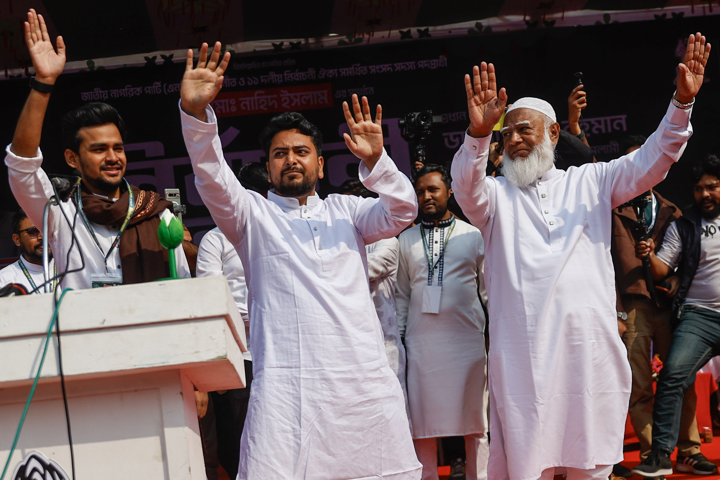 Jamaat-e-Islami Amir Shafiqur Rahman stands with Nahid Islam and Asia Mahmud Sahib Bhuiyan during an election campaign.