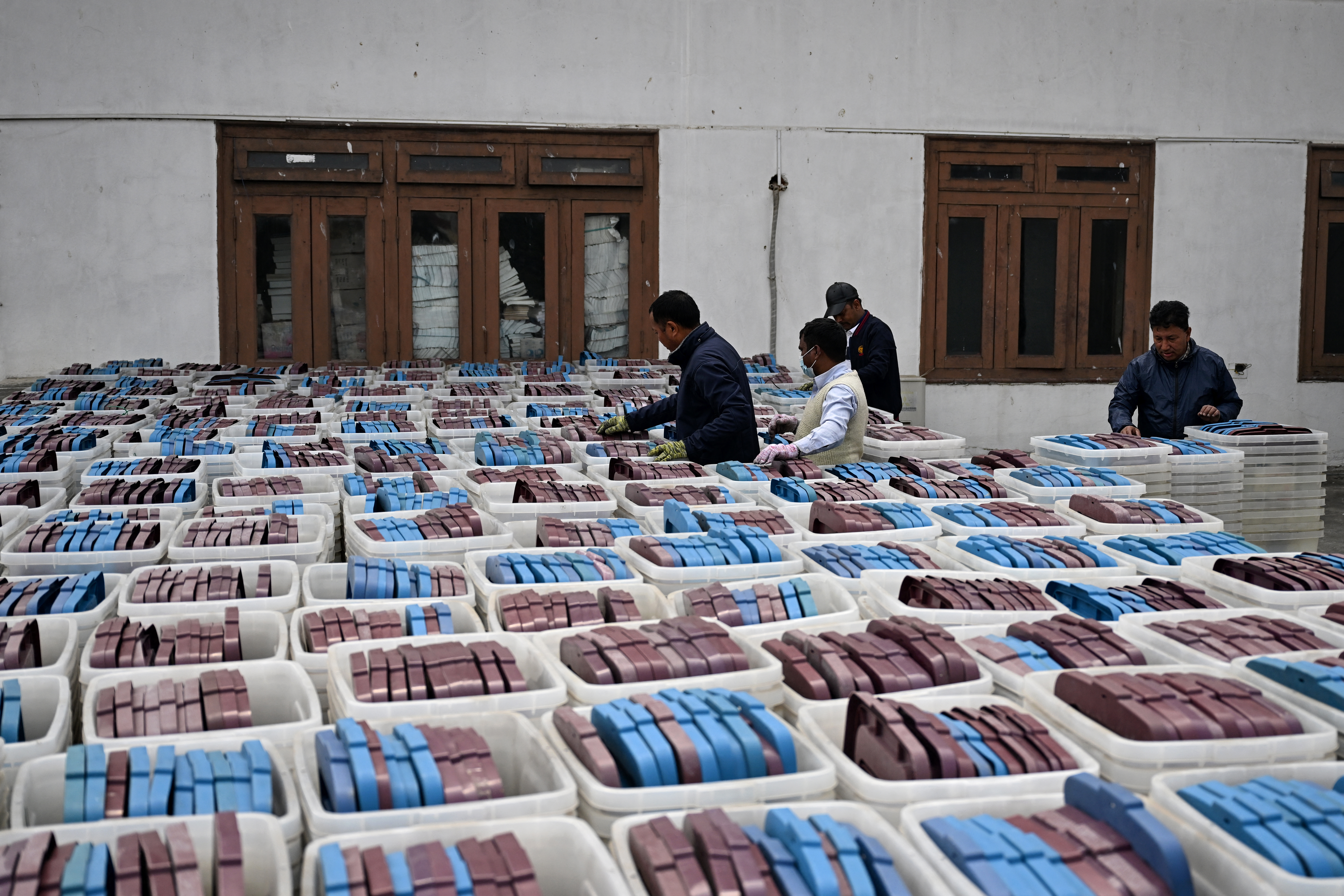 Election officials inspect ballot boxes before they are dispatched from the Election Commission office in Kathmandu on February 9, 2026 ahead of Nepal's general elections.