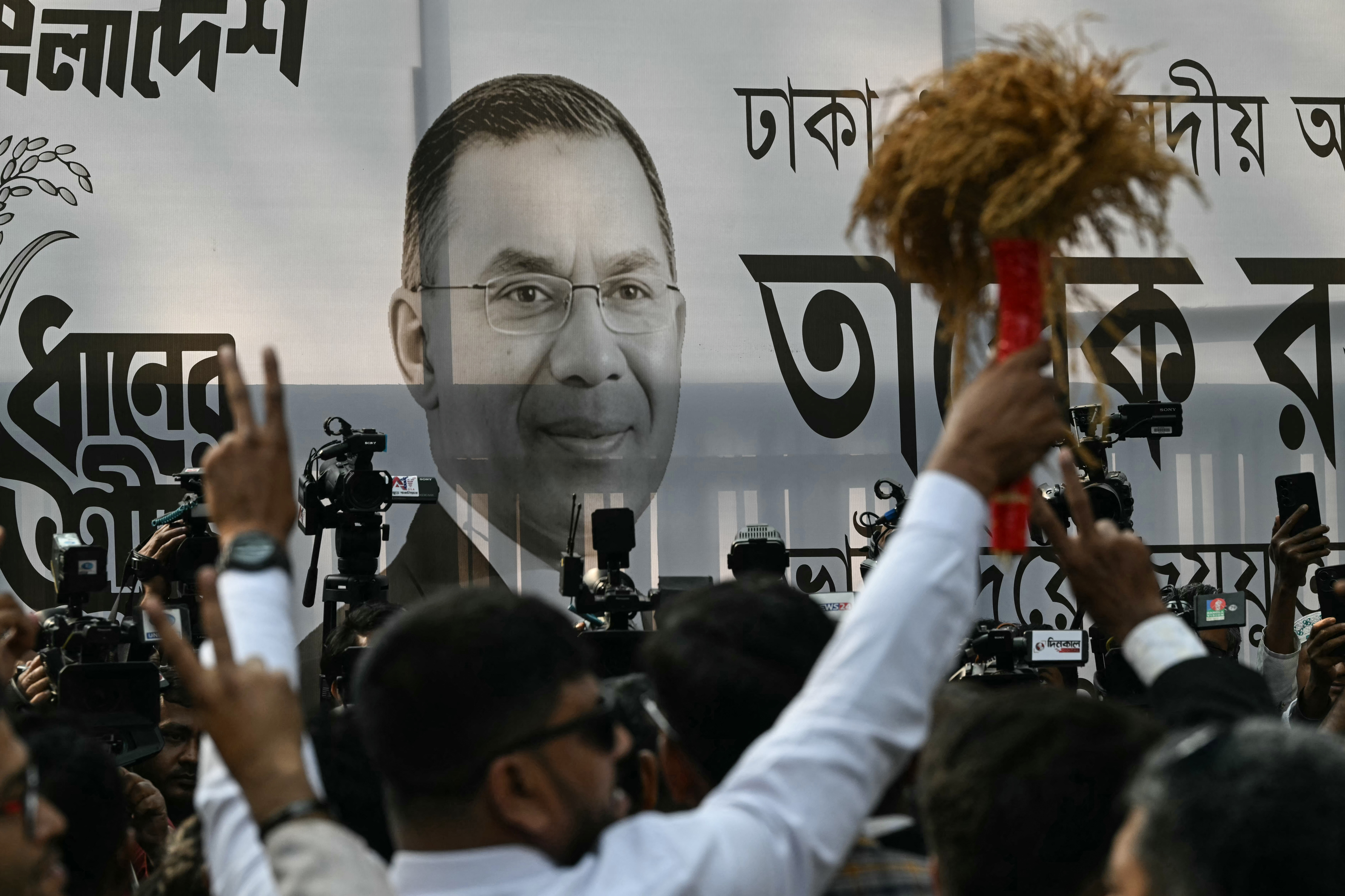 A poster of Bangladesh Nationalist Party (BNP) chairman and election candidate Tarique Rahman is displayed as supporters gather outside the party office in Dhaka on February 13, 2026.