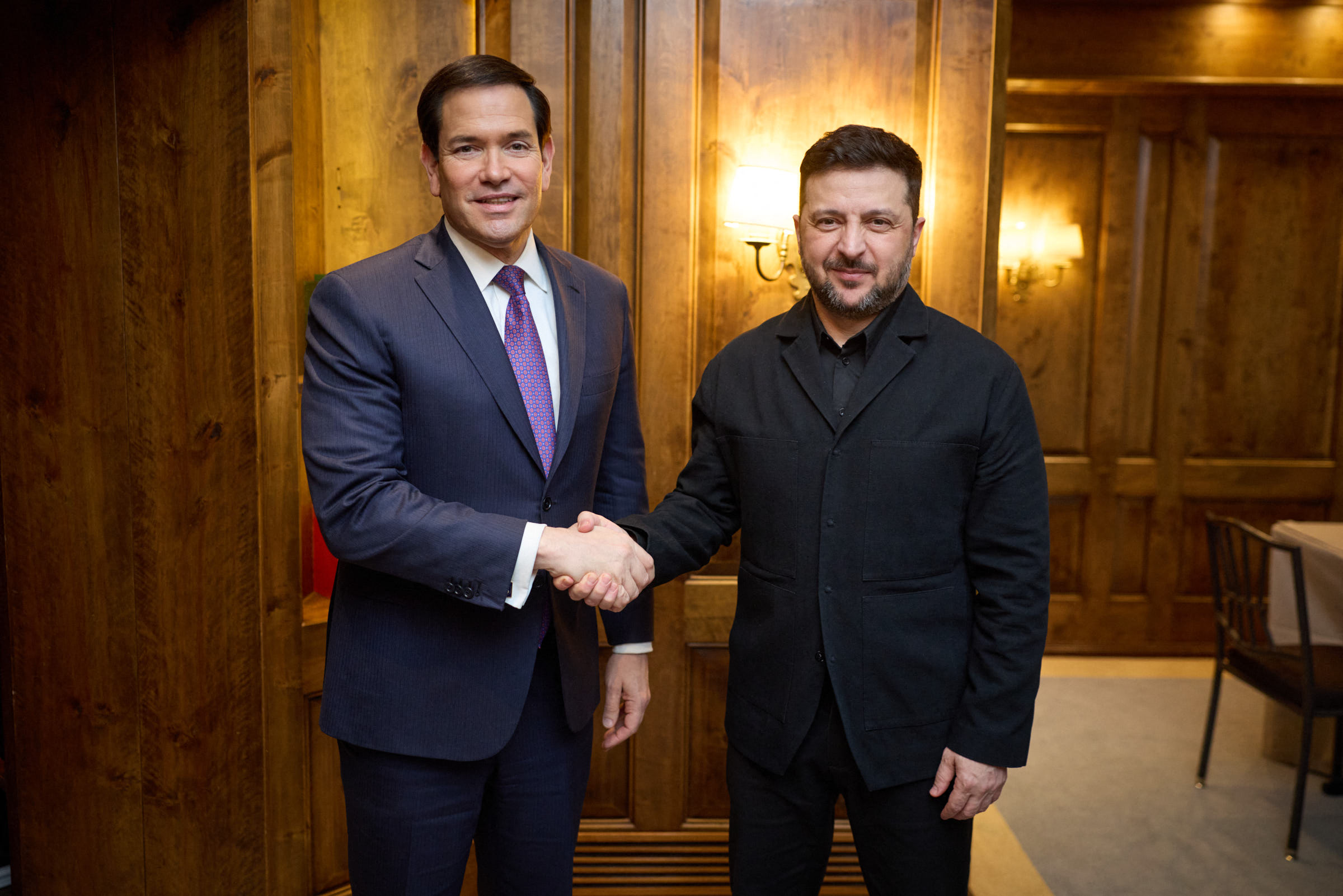 This handout photograph taken and released on February 14, 2026 by the Ukrainian Presidential Press Service, shows Ukraine's President Volodymyr Zelensky (R) shaking hands with US Secretary of State Marco Rubio (L) at the 62nd Munich Security Conference (MSC) in Munich.